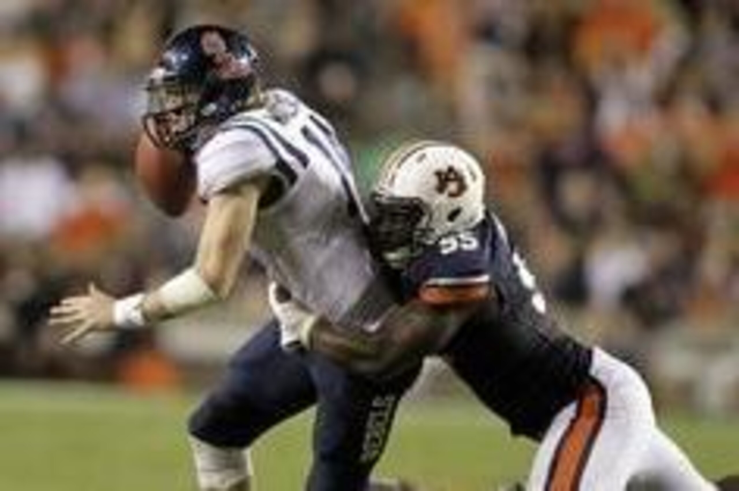 Oct 5, 2013; Auburn, AL, USA; Mississippi Rebels quarterback Bo Wallace (14) is tackled by Auburn Tigers defensive end Carl Lawson (55) during the first half at Jordan Hare Stadium. Mandatory Credit: John Reed-USA TODAY Sports