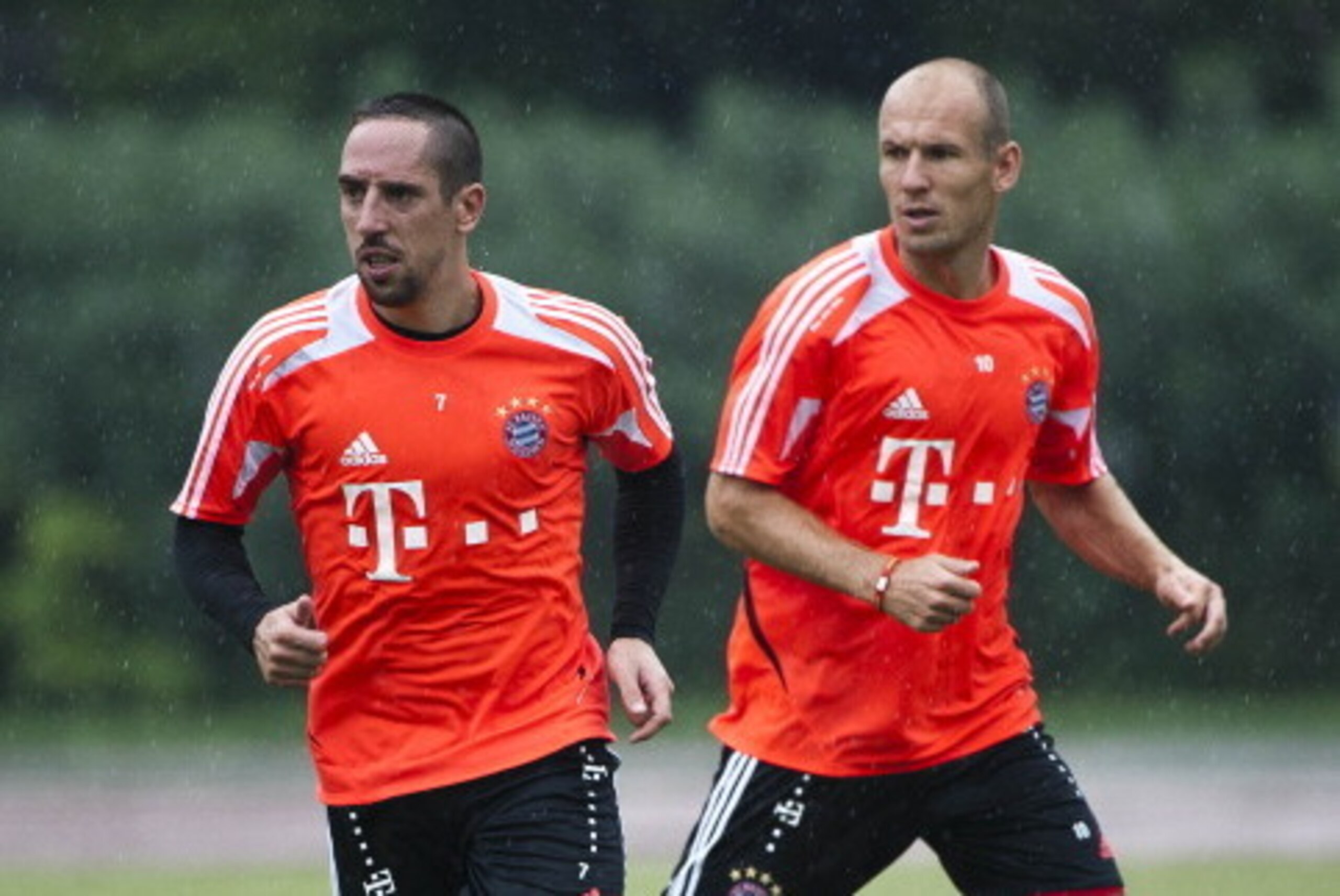 GUANGZHOU, CHINA - JULY 26:  Arjen Robben (R) and Franck Ribery of Bayern Muenchen in action during a training session ahead the friendly match against VfL Wolfsburg as part of the Audi Football Summit 2012 on July 26, 2012 at the Tianhe Sports Stadium in