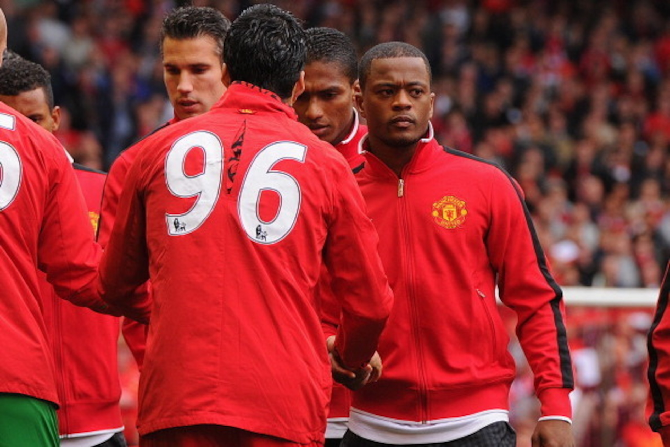LIVERPOOL, ENGLAND - SEPTEMBER 23:  Patrice Evra of Manchester United shakes hands with Luis Suarez of Liverpool before the Barclays Premier League match between Liverpool and Manchester United at Anfield on September 23, 2012 in Liverpool, England.  (Pho