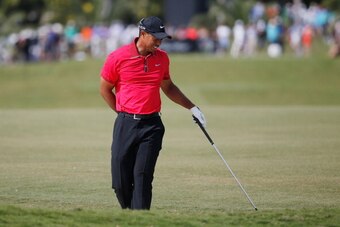 DORAL, FL - MARCH 09:  Tiger Woods grimages after playing a bunker shot on the fifth hole during the final round of the World Golf Championships-Cadillac Championship at Trump National Doral on March 9, 2014 in Doral, Florida.  (Photo by Chris Trotman/Get