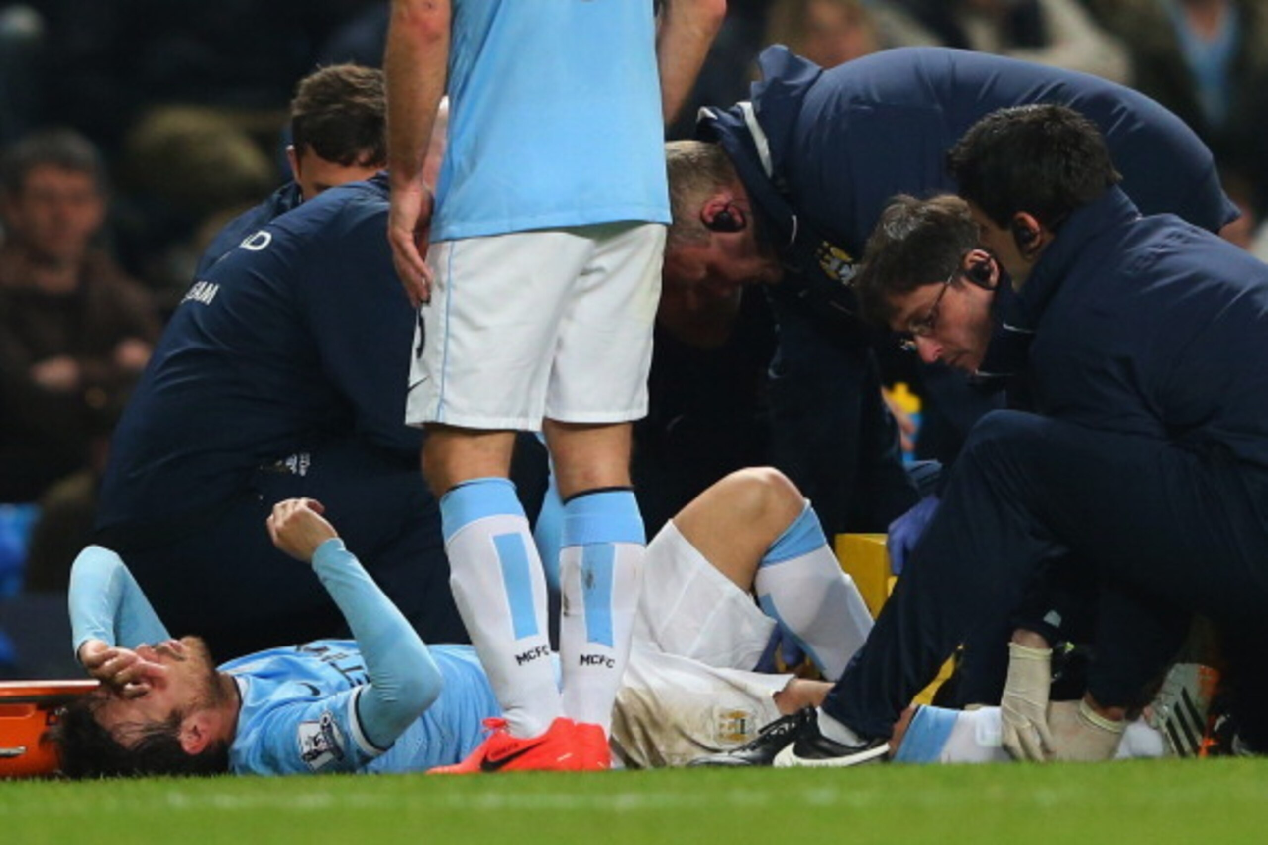 MANCHESTER, ENGLAND - APRIL 21:  An injured David Silva of Manchester City is given treatment during the Barclays Premier League match between Manchester City and West Bromwich Albion at Etihad Stadium on April 21, 2014 in Manchester, England.  (Photo by 