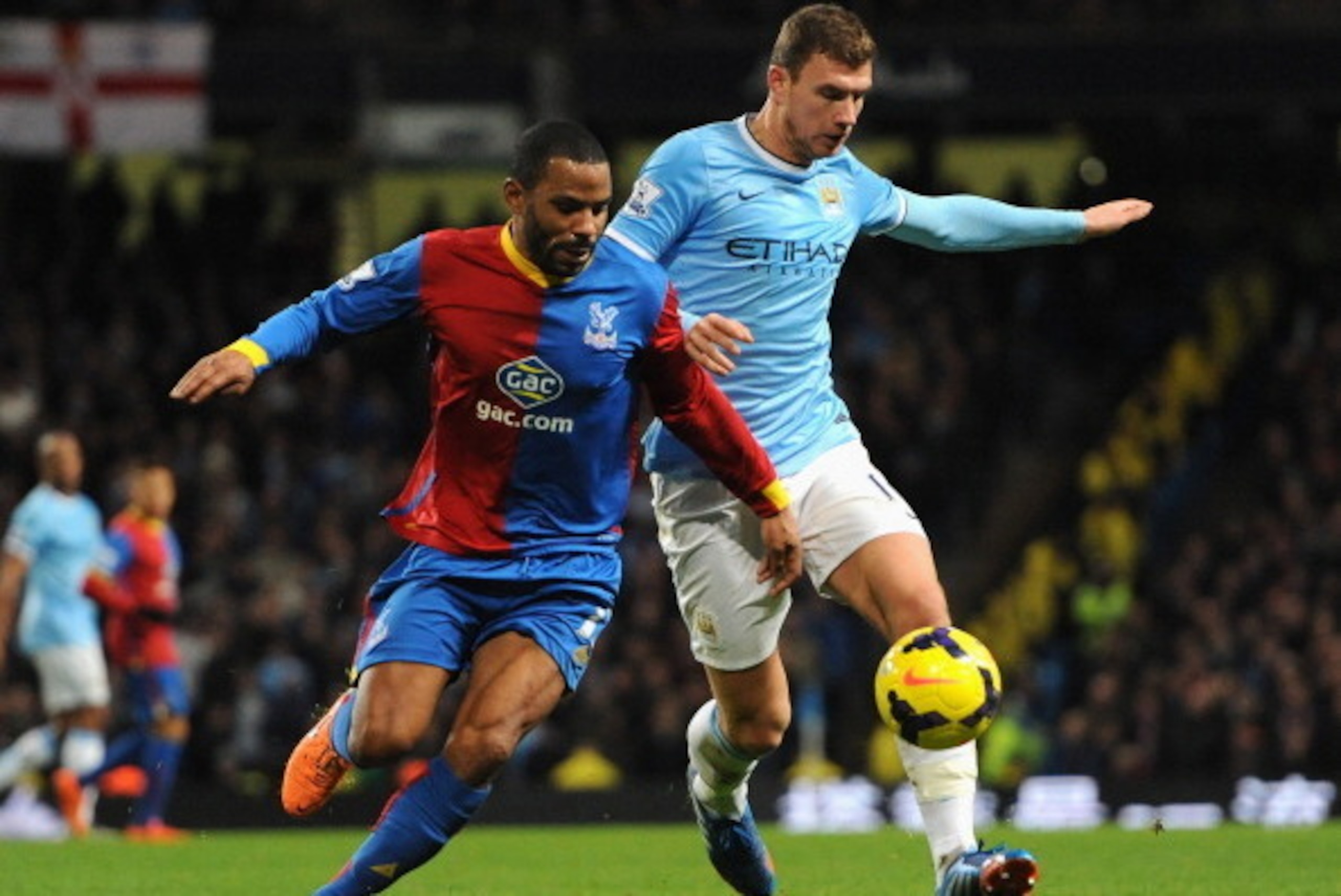 MANCHESTER, ENGLAND - DECEMBER 28:  Jason Puncheon of Crystal Palace competes with Edin Dzeko of Manchester City during the Barclays Premier League match between Manchester City and Crystal Palace at the Etihad Stadium on December 28, 2013 in Manchester, 