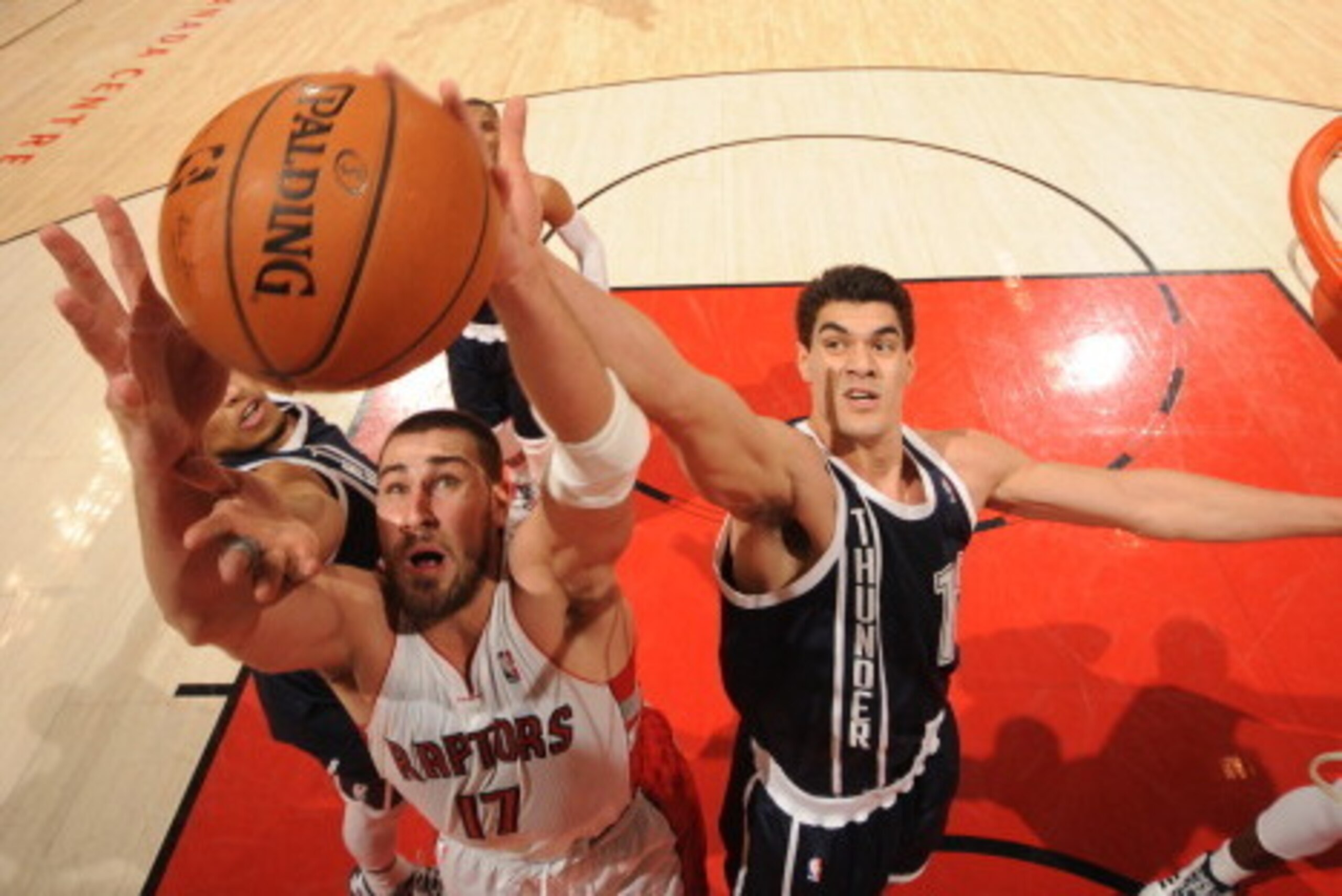 TORONTO, CANADA - March 21: Jonas Valanciunas #17 of the Toronto Raptors grabs a rebound against the Oklahoma City Thunder on March 21, 2014 at the Air Canada Centre in Toronto, Ontario, Canada.  NOTE TO USER: User expressly acknowledges and agrees that, 