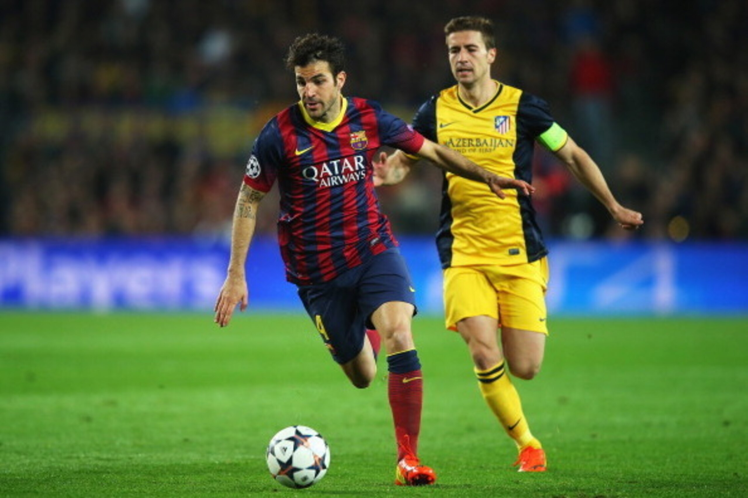 BARCELONA, SPAIN - APRIL 01:  Cesc Fabregas of Barcelona goes past Gabi of Club Atletico de Madrid during the UEFA Champions League Quarter Final first leg match between FC Barcelona and Club Atletico de Madrid at Camp Nou on April 1, 2014 in Barcelona, S