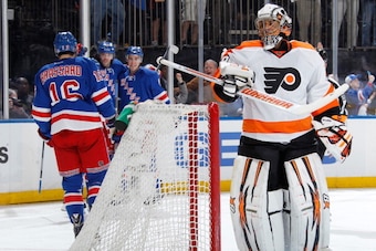 NEW YORK, NY - APRIL 20:  Ray Emery #29 of the Philadelphia Flyers looks on as Benoit Pouliot #67 and the New York Rangers celebrate after a first-period goal in Game Two of the First Round of the 2014 Stanley Cup Playoffs at Madison Square Garden on Apri