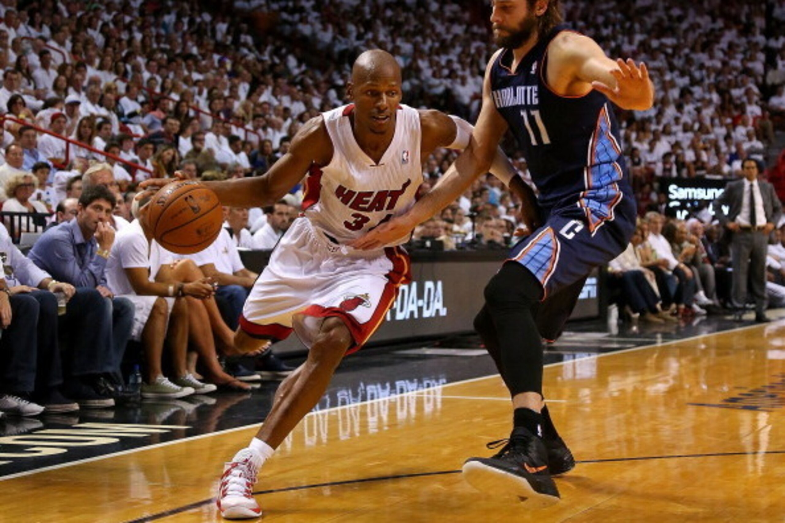 MIAMI, FL - APRIL 20: Ray Allen #34 of the Miami Heat drives on Josh McRoberts #11 of the Charlotte Bobcats during Game 1 of the Eastern Conference Quarterfinals of the 2014 NBA Playoffs at American Airlines Arena on April 20, 2014 in Miami, Florida. NOTE