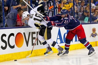 COLUMBUS, OH - APRIL 21:  James Wisniewski #21 of the Columbus Blue Jackets checks James Neal #18 of the Pittsburgh Penguins while battling for control of the puck during the third period in Game Three of the First Round of the 2014 NHL Stanley Cup Playof