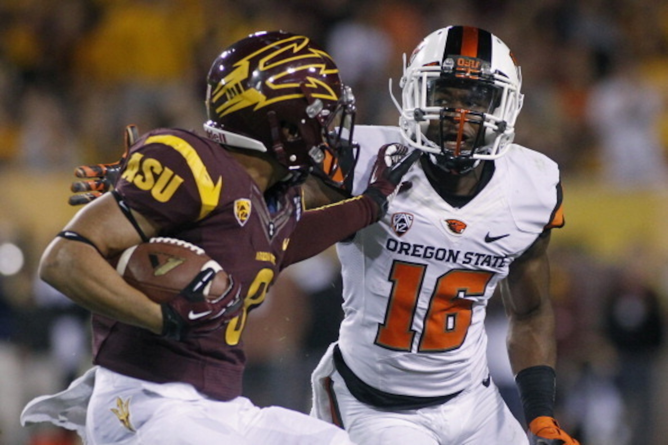 TEMPE, AZ - NOVEMBER 16:  Defensive back Rashaad Reynolds #16 of the Oregon State Beavers tries to tackle D.J. Foster #8 of the Arizona State Sun Devils during the first quarter of their college football game at Sun Devil Stadium on November 16, 2013 in T