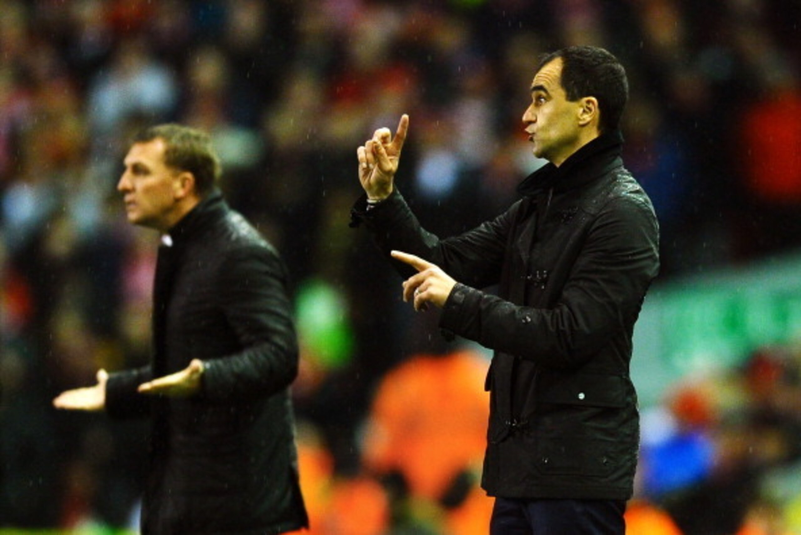 LIVERPOOL, ENGLAND - JANUARY 28:  Roberto Martinez the Everton manager directs his players as Brendan Rodgers the Liverpool manager reacts during the Barclays Premier League match between Liverpool and Everton at Anfield on January 28, 2014 in Liverpool, 
