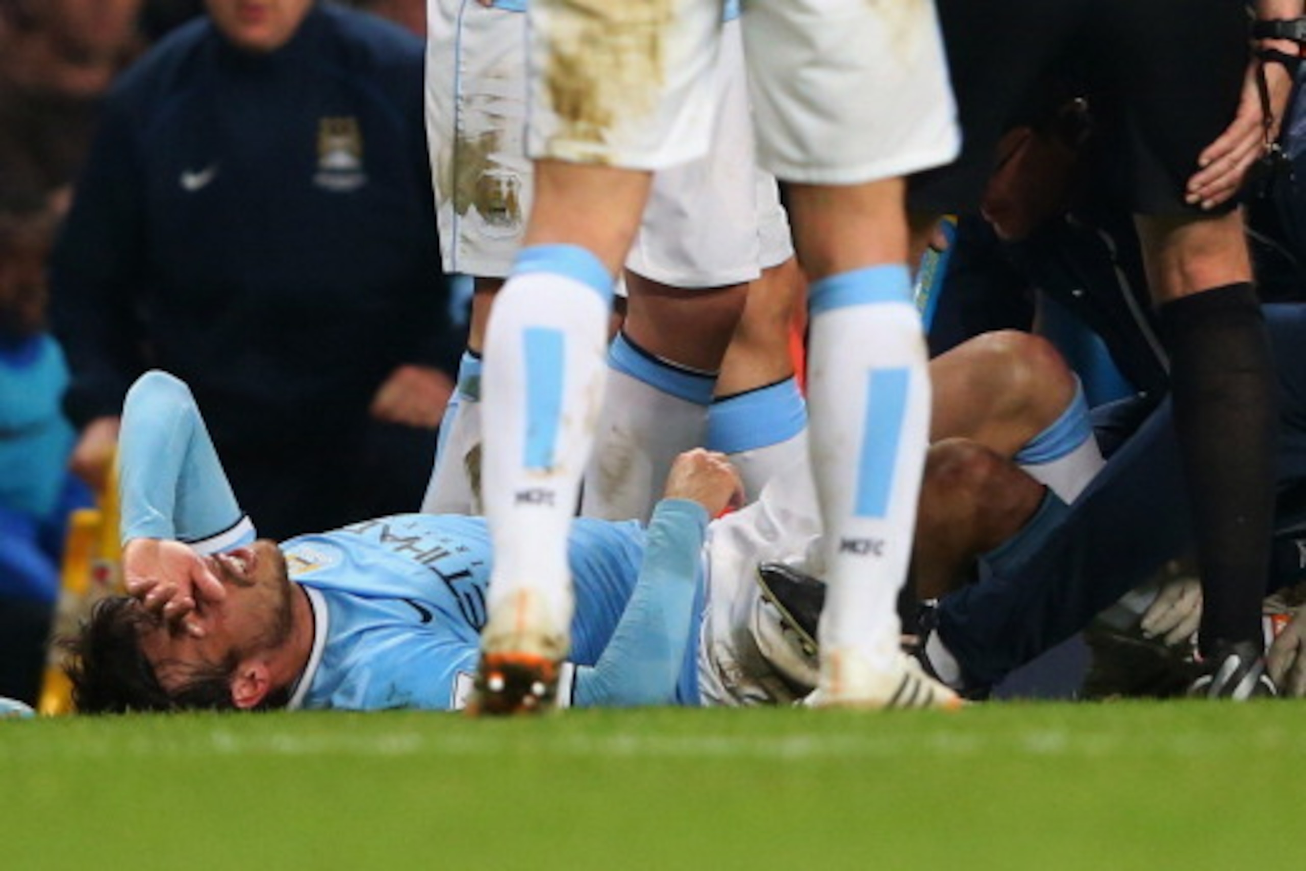 MANCHESTER, ENGLAND - APRIL 21:  An injured David Silva of Manchester City is given treatment during the Barclays Premier League match between Manchester City and West Bromwich Albion at Etihad Stadium on April 21, 2014 in Manchester, England.  (Photo by