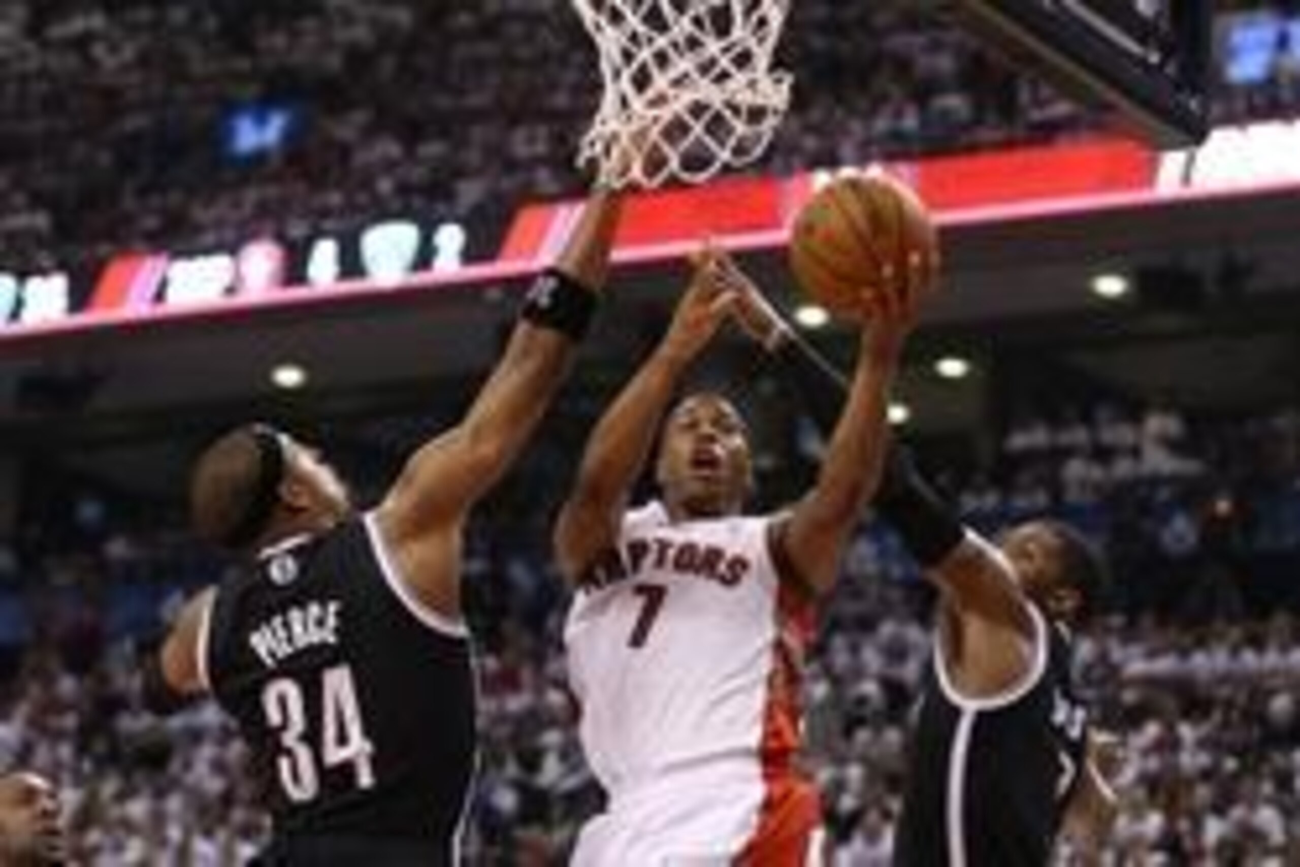 Apr 19, 2014; Toronto, Ontario, CAN; Toronto Raptors point guard Kyle Lowry (7) goes to the basket against Brooklyn Nets forward Paul Pierce (34) in game one during the first round of the 2014 NBA Playoffs at Air Canada Centre. Mandatory Credit: Tom Szcze