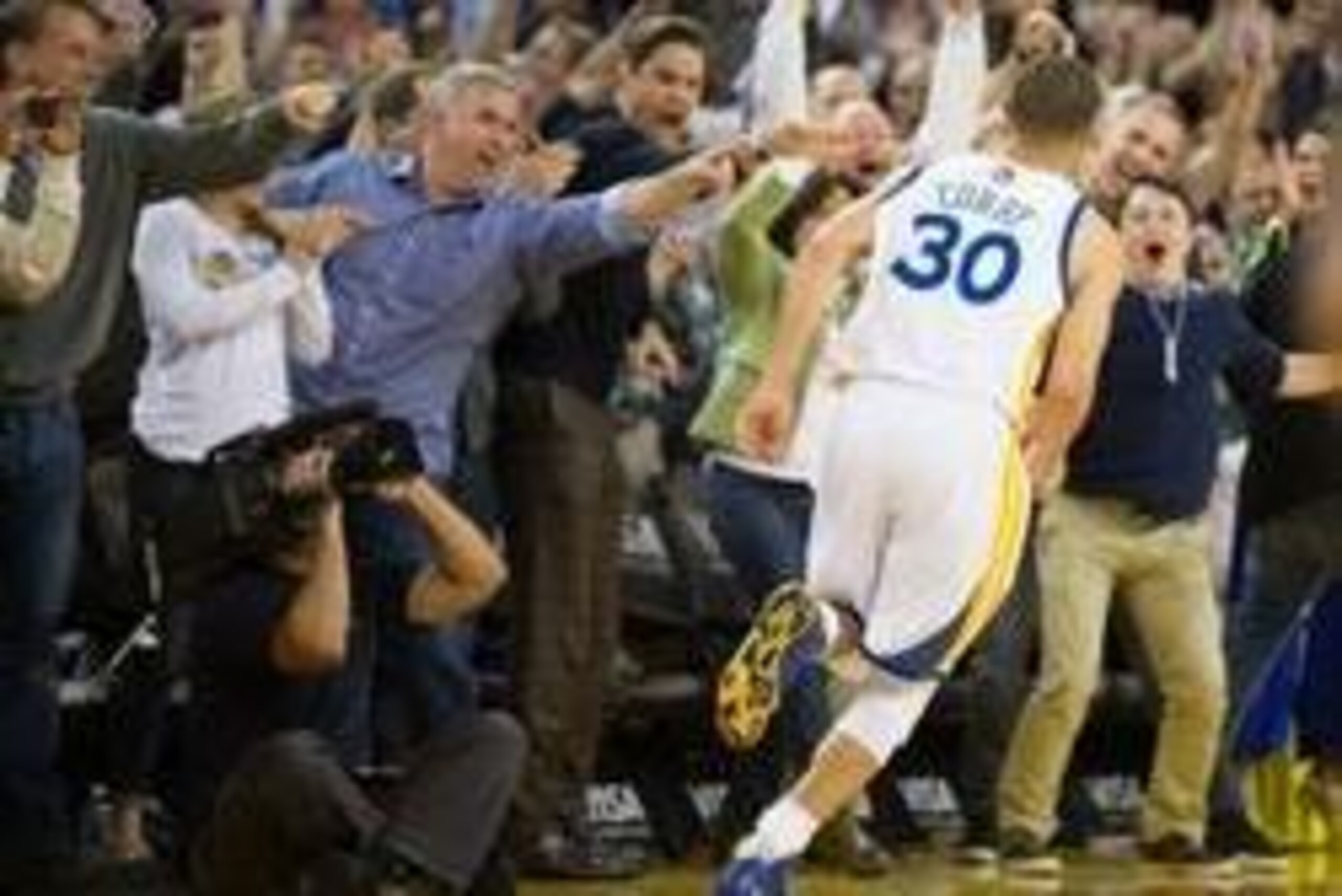 Mar 28, 2014; Oakland, CA, USA; Fans celebrate after a basket by Golden State Warriors guard Stephen Curry (30) during the fourth quarter against the Memphis Grizzlies at Oracle Arena. The Golden State Warriors defeated the Memphis Grizzlies 100-93. Manda Mar 28, 2014; Oakland, CA, USA; Fans celebrate after a basket by Golden State Warriors guard Stephen Curry (30) during the fourth quarter against the Memphis Grizzlies at Oracle Arena. The Golden State Warriors defeated the Memphis Grizzlies 100-93. Manda
