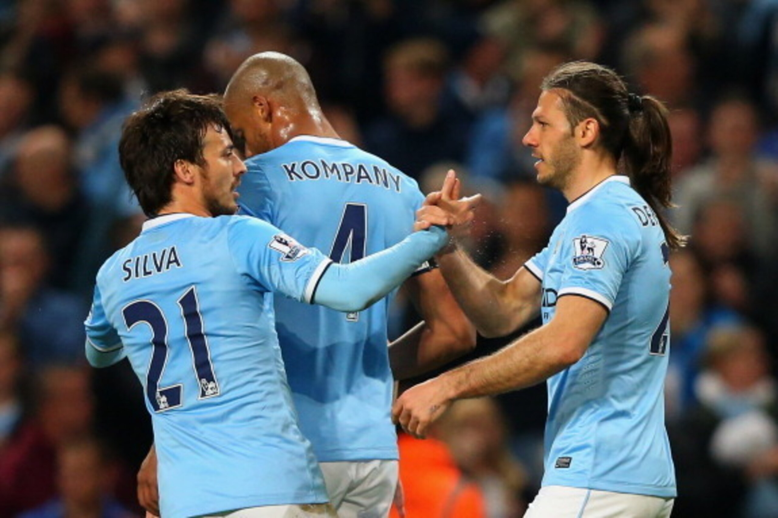MANCHESTER, ENGLAND - APRIL 21:  Martin Demichelis of Manchester City (R) celebrates with David Silva (21) and Vincent Kompany (4) as he scores their third goal during the Barclays Premier League match between Manchester City and West Bromwich Albion at E