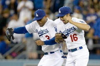 LOS ANGELES, CA - APRIL 19:  Carl Crawford #3, Andre Ethier #16 and Matt Kemp #27 of the Los Angeles Dodgers celebrate an 8-6 win over the Arizona Diamondbacks at Dodger Stadium on April 19, 2014 in Los Angeles, California.  (Photo by Harry How/Getty Imag