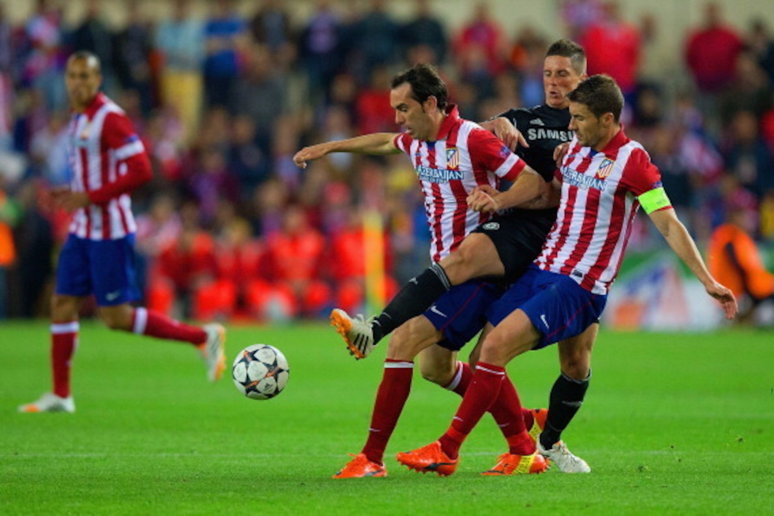 MADRID, SPAIN - APRIL 22:  Fernando Torres of Chelsea is closed down by and Diego Godin and Gabi of Club Atletico de Madrid during the UEFA Champions League Semi Final first leg match between Club Atletico de Madrid and Chelsea at Vicente Calderon Stadium