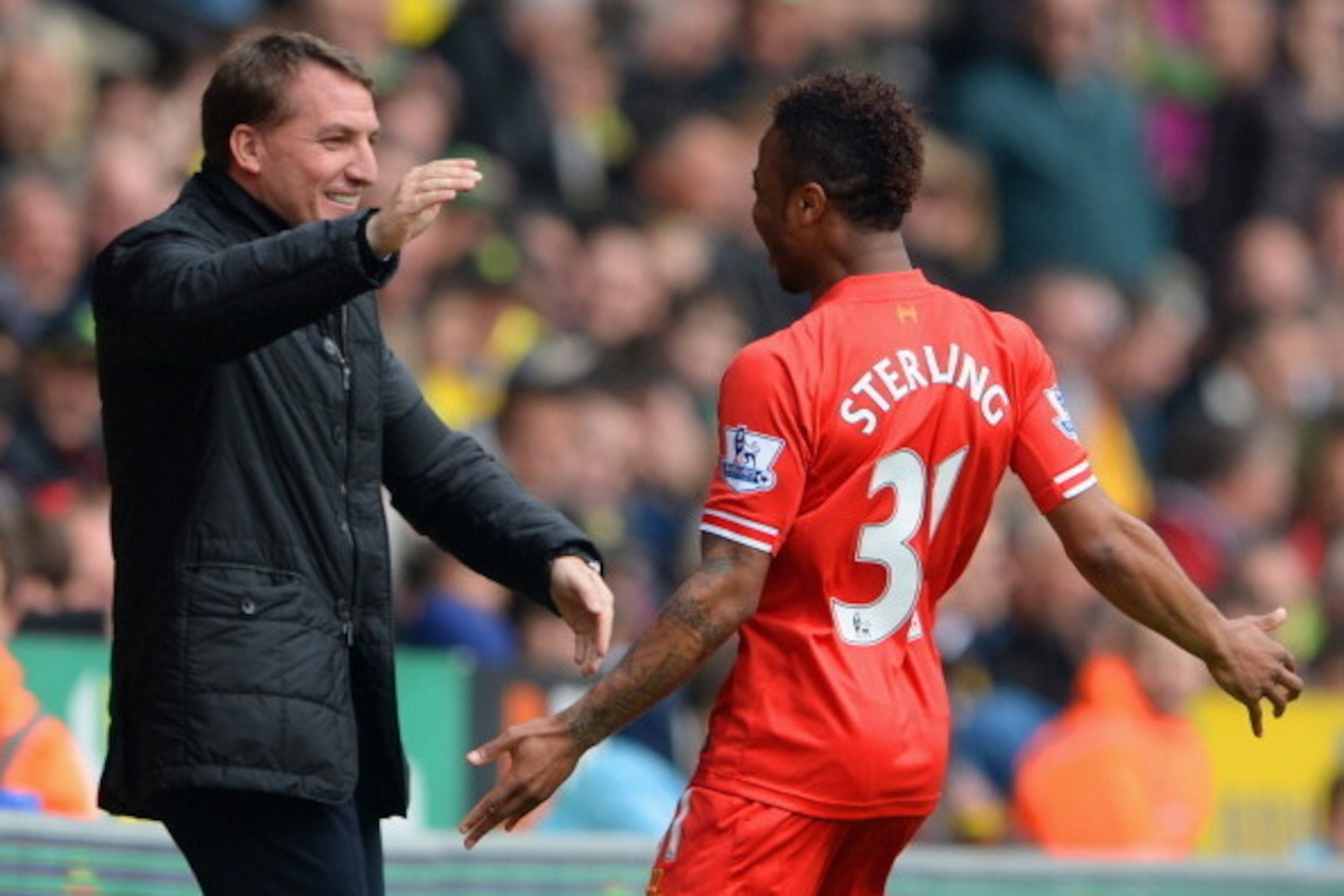 NORWICH, ENGLAND - APRIL 20: Raheem Sterling of Liverpool celebrates scoring the opening goal with Manager Brendan Rodgers of Liverpool during the Barclays Premier League match between Norwich City and Liverpool at Carrow Road on April 20, 2014 in Norwic NORWICH, ENGLAND - APRIL 20: Raheem Sterling of Liverpool celebrates scoring the opening goal with Manager Brendan Rodgers of Liverpool during the Barclays Premier League match between Norwich City and Liverpool at Carrow Road on April 20, 2014 in Norwic