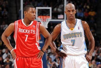 DENVER - MARCH 9:  (L-R) Kyle Lowry #7 of the Houston Rockets and Chauncey Billups #7 of the Denver Nuggets stand on the court during the game on March 9, 2009 at the Pepsi Center in Denver, Colorado.  The Rockets won 97-95.   NOTE TO USER: User expressly