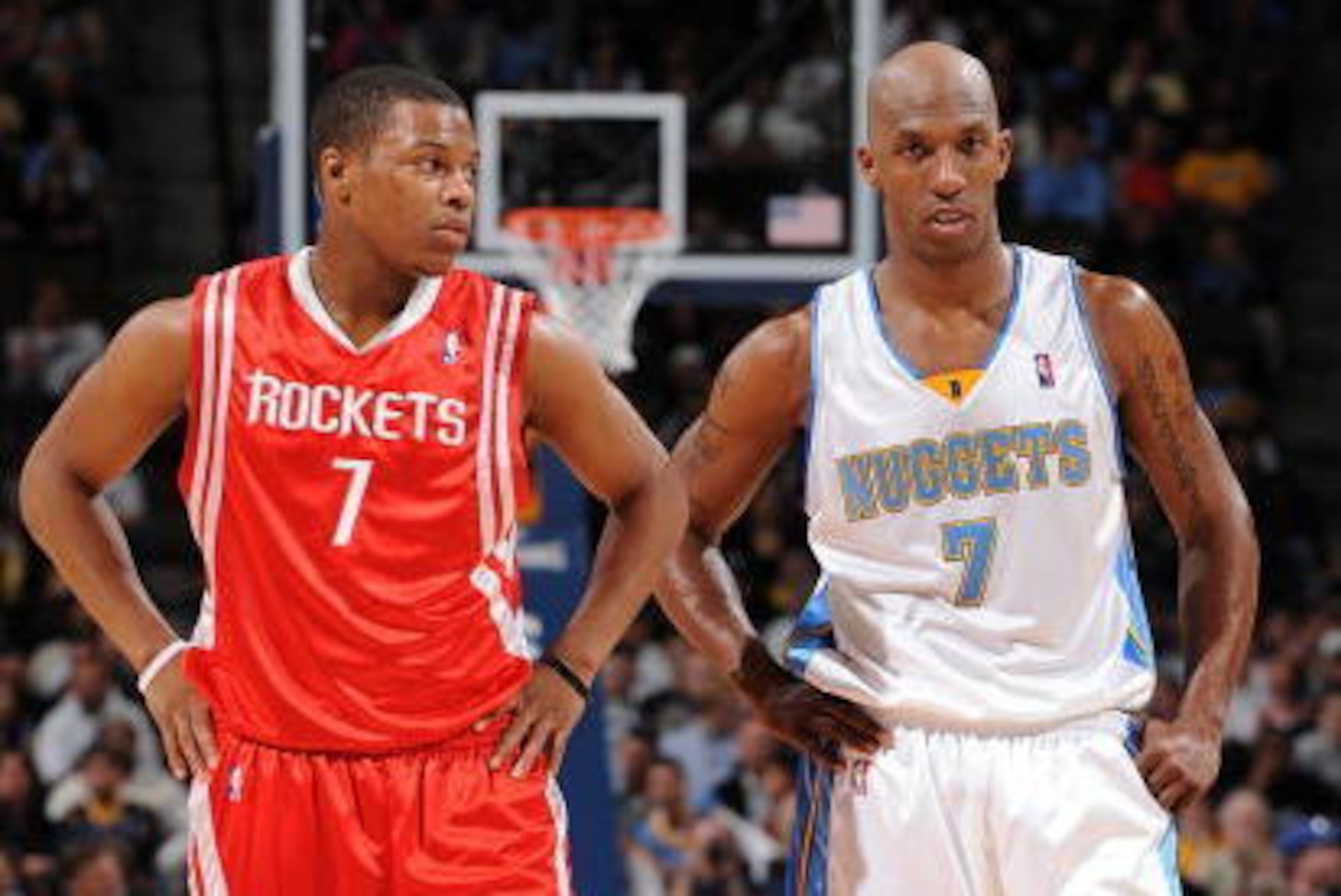 DENVER - MARCH 9:  (L-R) Kyle Lowry #7 of the Houston Rockets and Chauncey Billups #7 of the Denver Nuggets stand on the court during the game on March 9, 2009 at the Pepsi Center in Denver, Colorado.  The Rockets won 97-95.   NOTE TO USER: User expressly