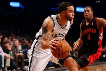 NEW YORK, NY - NOVEMBER 03: Deron Williams #8 of the Brooklyn Nets drives to the basket as Kyle Lowry #3 of the Toronto Raptors defends at the Barclays Center on November 3, 2012 in the Brooklyn borough of New York City. NOTE TO USER: User expressly ackno