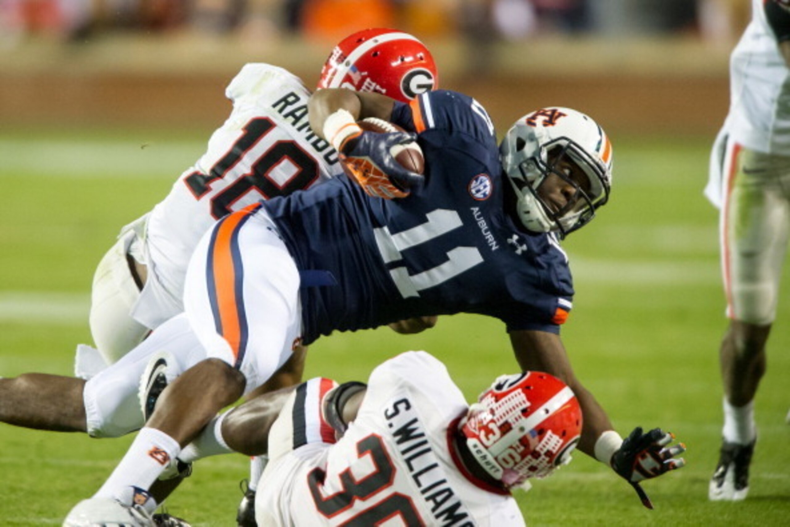 AUBURN, AL - NOVEMBER 10:  Strong safety Shawn Williams #36 and free safety Bacarri Rambo #18 of the Georgia Bulldogs tackle tight end Brandon Fulse #11 of the Auburn Tigers on November 10, 2012 at Jordan-Hare Stadium in Auburn, Alabama. Georgia leads Aub
