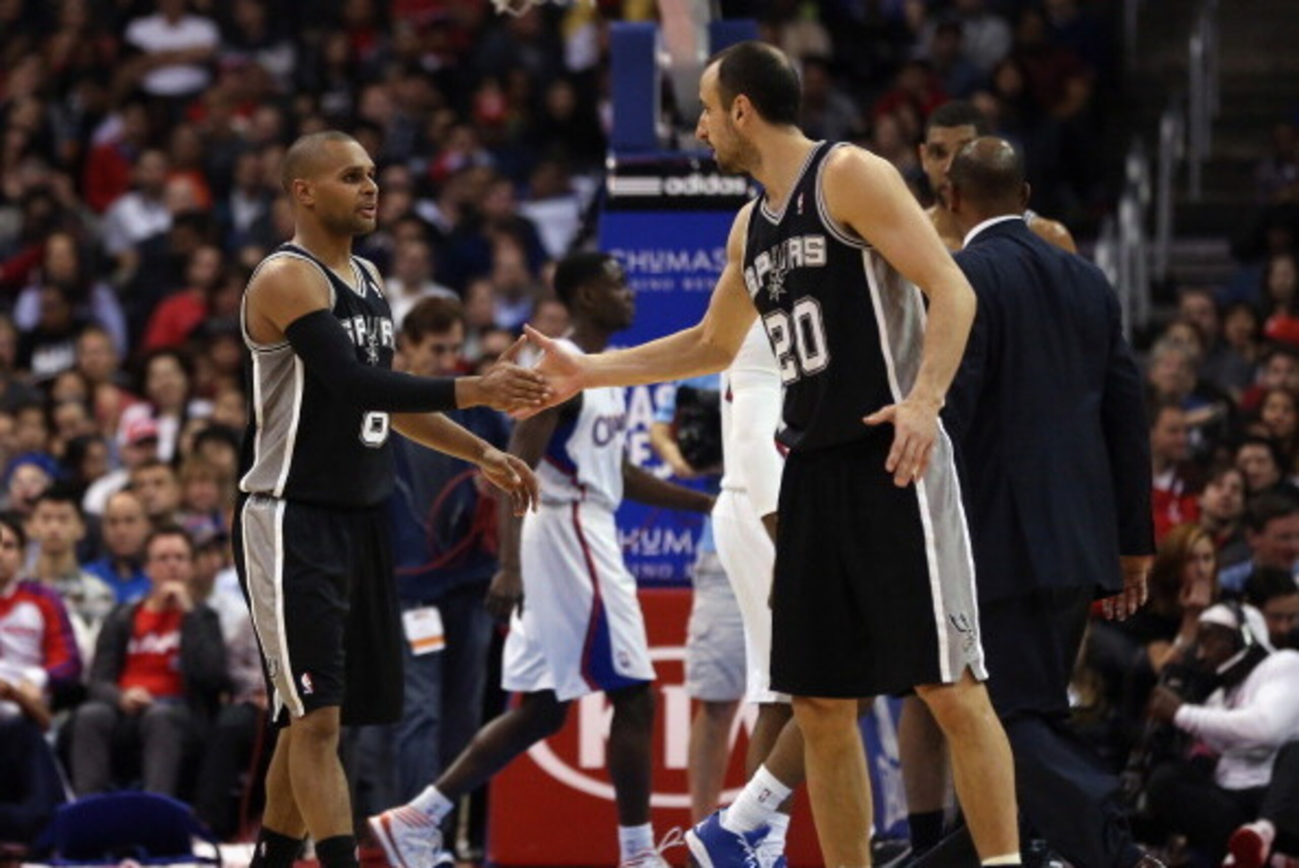 LOS ANGELES, CA - FEBRUARY 18:  Patty Mills (L) #8 of the San Antonio Spurs is congratulated by Manu Ginobili #20 after scoring a basket against the Los Angeles Clippers in the second half at Staples Center on February 18, 2014 in Los Angeles, California.