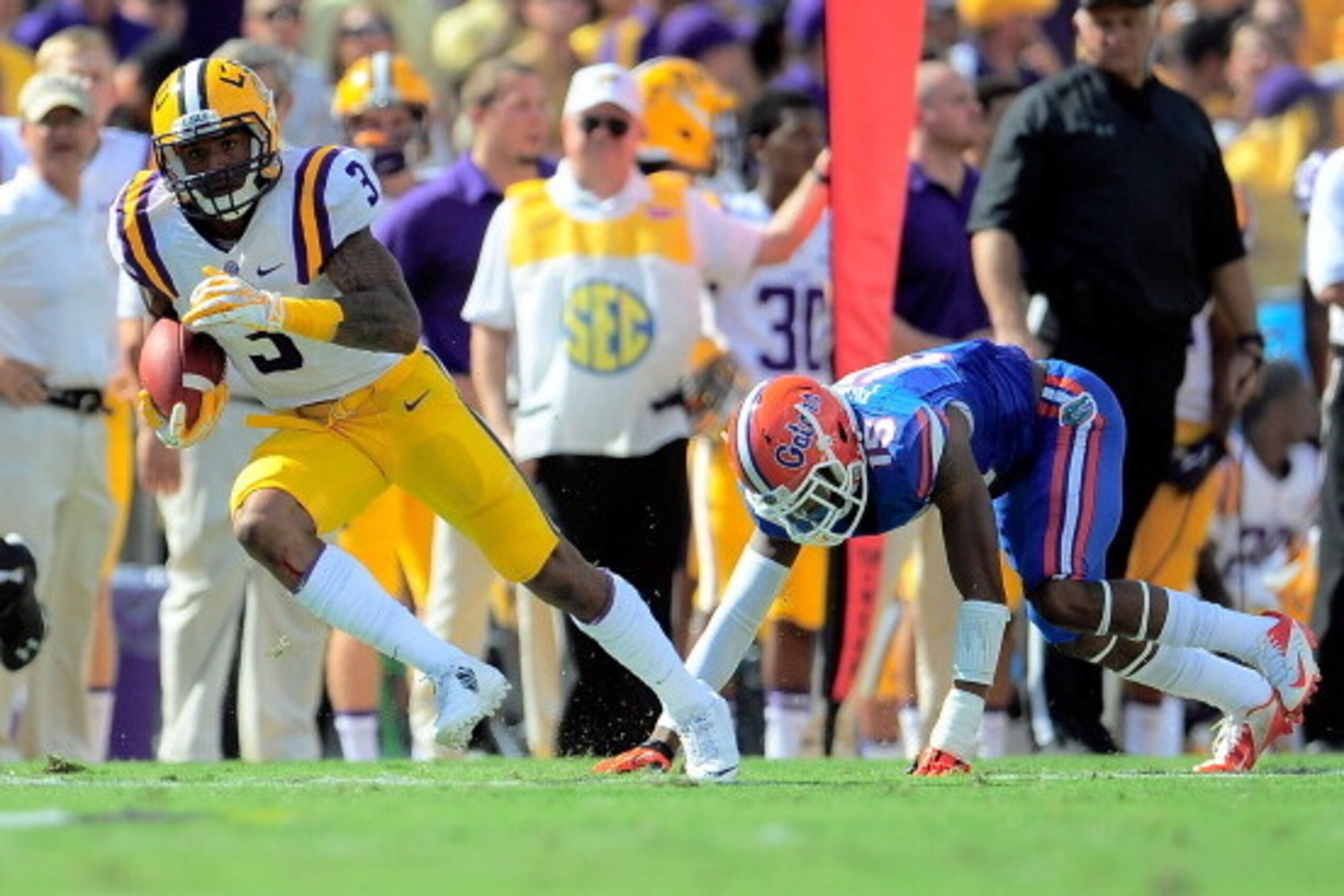 BATON ROUGE, LA - OCTOBER 12:  Odell Beckham Jr. #3 of the LSU Tigers catches a pass in front of Loucheiz Purifoy #15 of the Florida Gators during a game at Tiger Stadium on October 12, 2013 in Baton Rouge, Louisiana.  LSU won the game 17-6.  (Photo by St