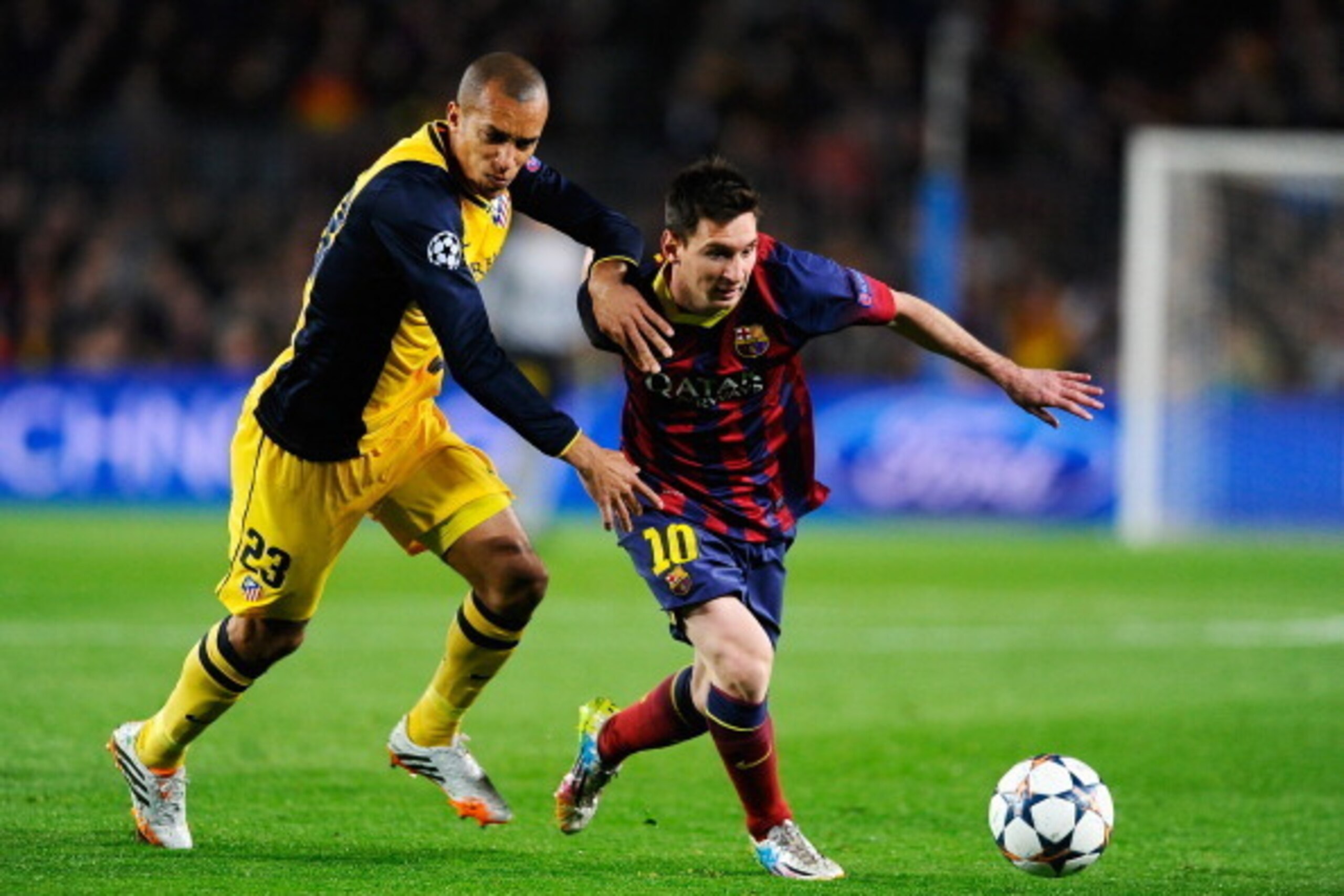 BARCELONA, SPAIN - APRIL 01:  Lionel Messi of Barcelona is challenged by Miranda of Club Atletico de Madrid during the UEFA Champions League Quarter Final first leg match between FC Barcelona and Club Atletico de Madrid at Camp Nou on April 1, 2014 in Bar