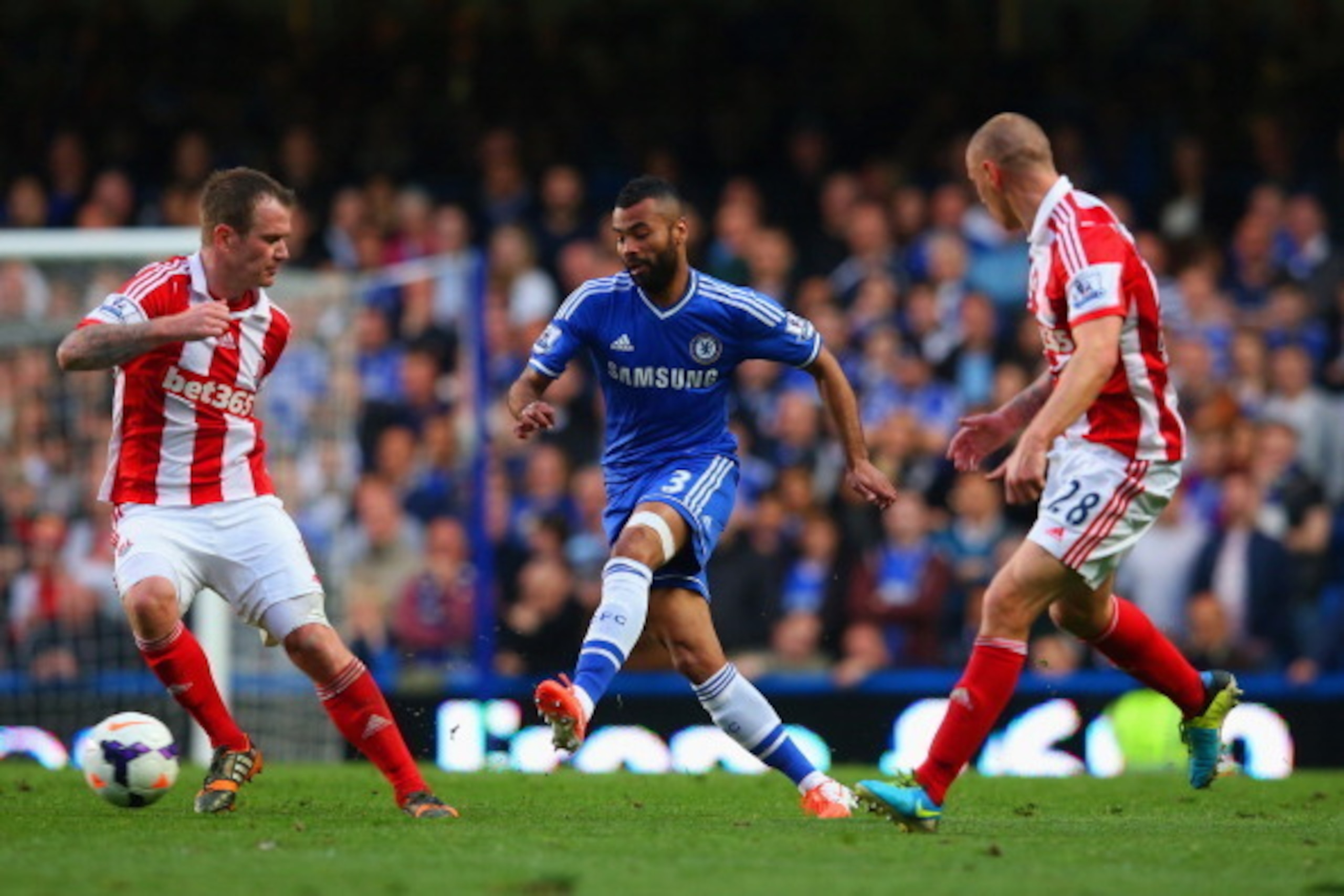 LONDON, ENGLAND - APRIL 05:  Ashley Cole of Chelsea is closed down by Charlie Adam of Stoke City and Andy Wilkinson of Stoke City during the Barclays Premier League match between Chelsea and Stoke City at Stamford Bridge on April 5, 2014 in London, Englan