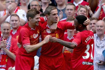 LIVERPOOL, ENGLAND - AUGUST 03: Jordan Henderson of Liverpool is congratulated by Steven Gerrard and Raheem Sterling after scoring the winning goal during the Steven Gerrard Testimonial Match between Liverpool and Olympiacos at Anfield on August 03, 2013