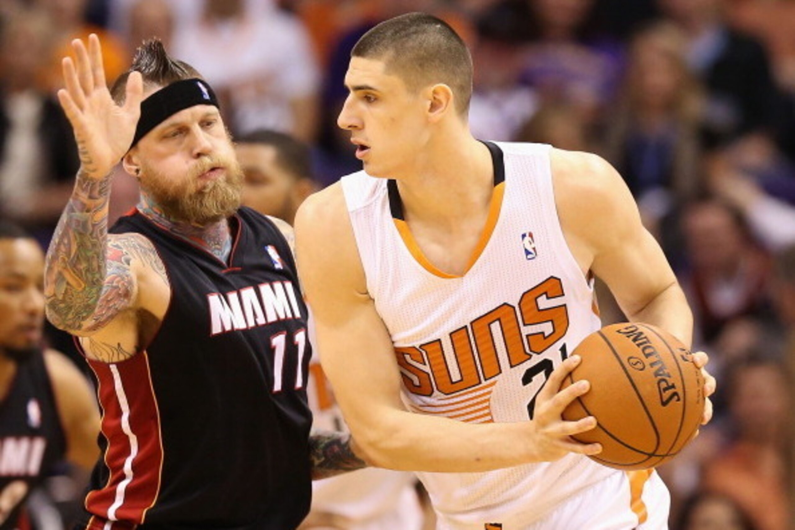 PHOENIX, AZ - FEBRUARY 11:  Alex Len #21 of the Phoenix Suns looks to pass against Chris Andersen #11 of the Miami Heat during the NBA game at US Airways Center on February 11, 2014 in Phoenix, Arizona. The Heat defeated the Suns 103-97.  NOTE TO USER: Us