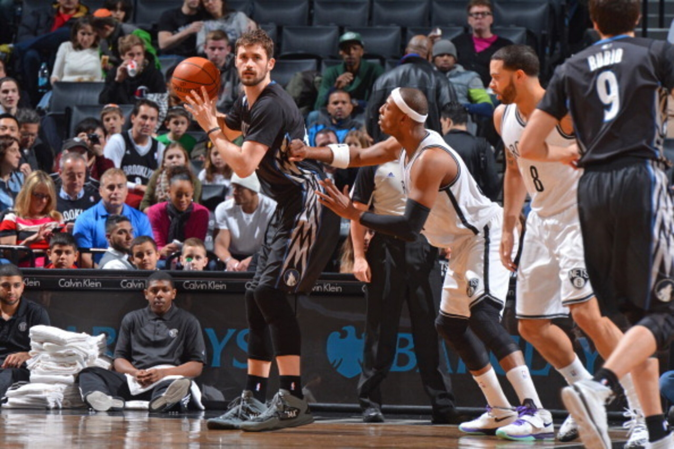 BROOKLYN, NY - March 30: Kevin Love #42 of the Minnesota Timberwolves handles the ball against Paul Pierce #34 of the Brooklyn Nets on March 30, 2014 at the Barclays Center in Brooklyn, New York. NOTE TO USER: User expressly acknowledges and agrees that, 