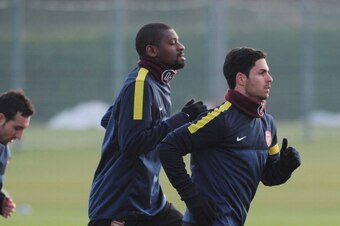 ST ALBANS, ENGLAND - FEBRUARY 18:  Mikel Arteta (R) and Abou Diaby of Arsenal warm up during a training session ahead of their UEFA Champions League round of 16 first leg match against FC Bayern Muenchen at London Colney on February 18, 2013 in St Albans,