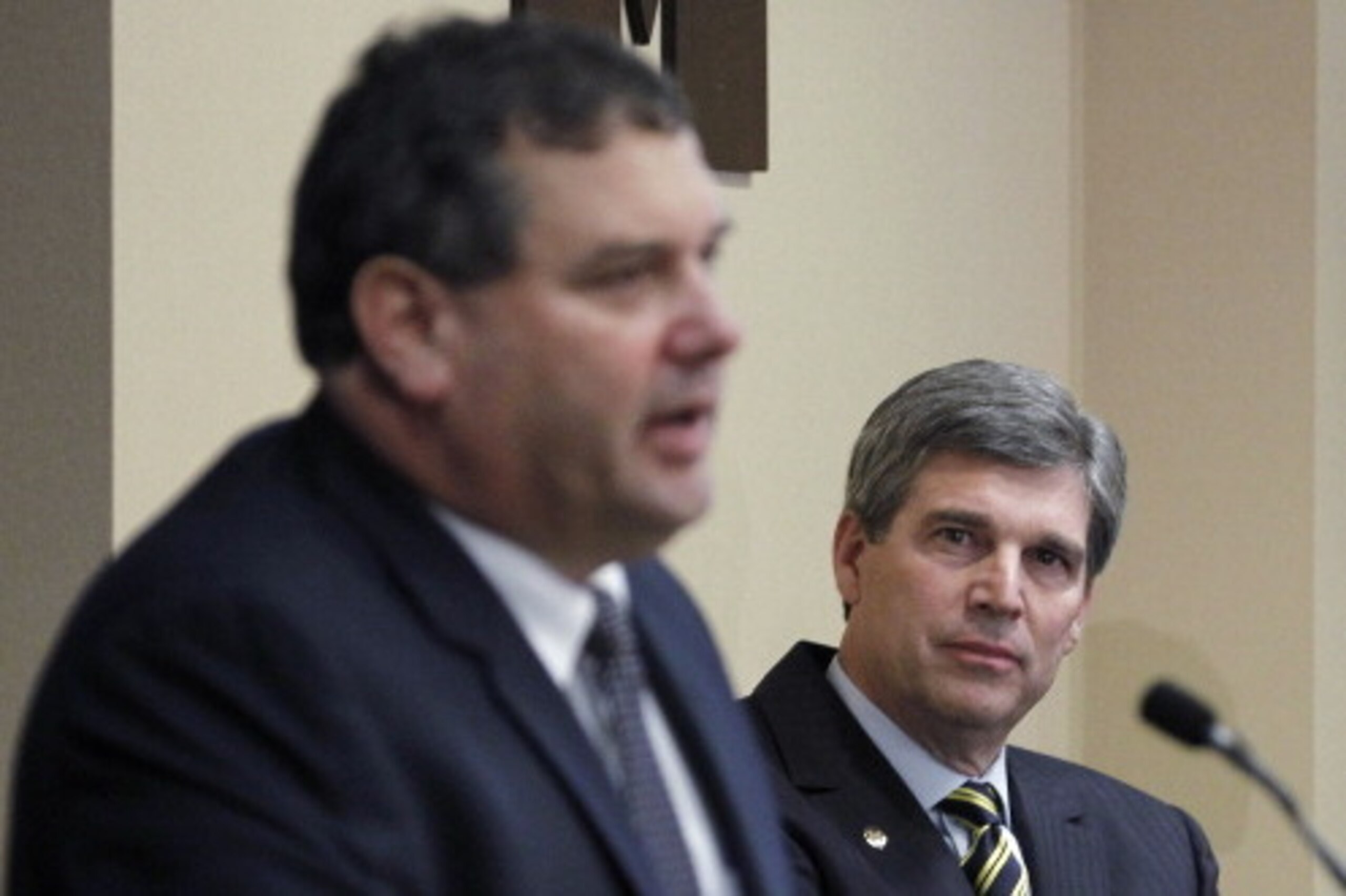 ANN ARBOR, MI - JANUARY 12:  New University of Michigan head football coach Brady Hoke (L) speaks to the media as, Athletic Director Dave Brandon looks on, after introducing Hoke as the nineteenth Michigan head football coach in Michigan history at the Ju