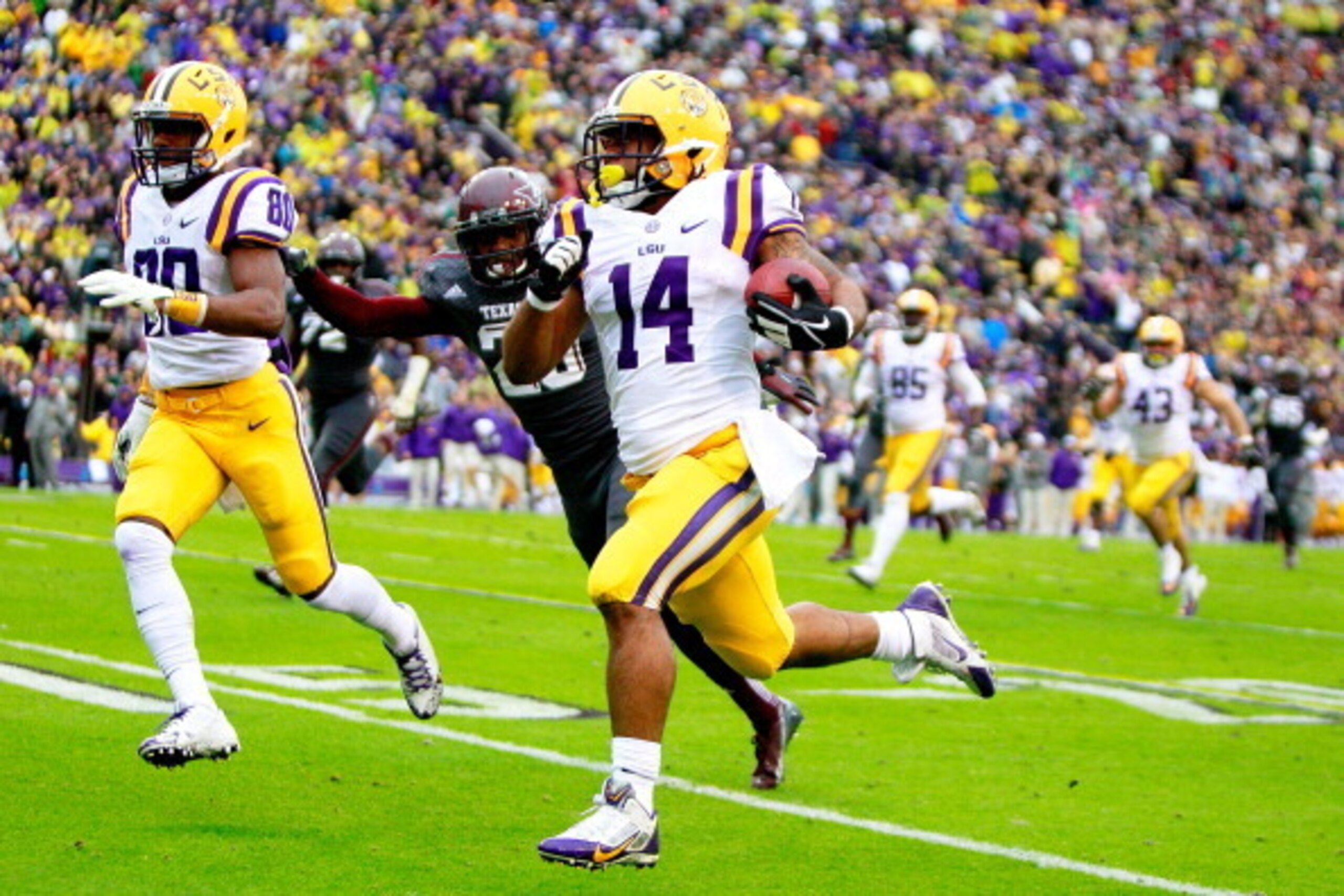 BATON ROUGE, LA - NOVEMBER 23:  Running Back Terrence Magee #14 of the LSU TIgiers rushes for a first down against the Texas A&M Aggies at Tiger Stadium on November 23, 2013 in Baton Rouge, Louisiana.  (Photo by Sean Gardner/Getty Images)