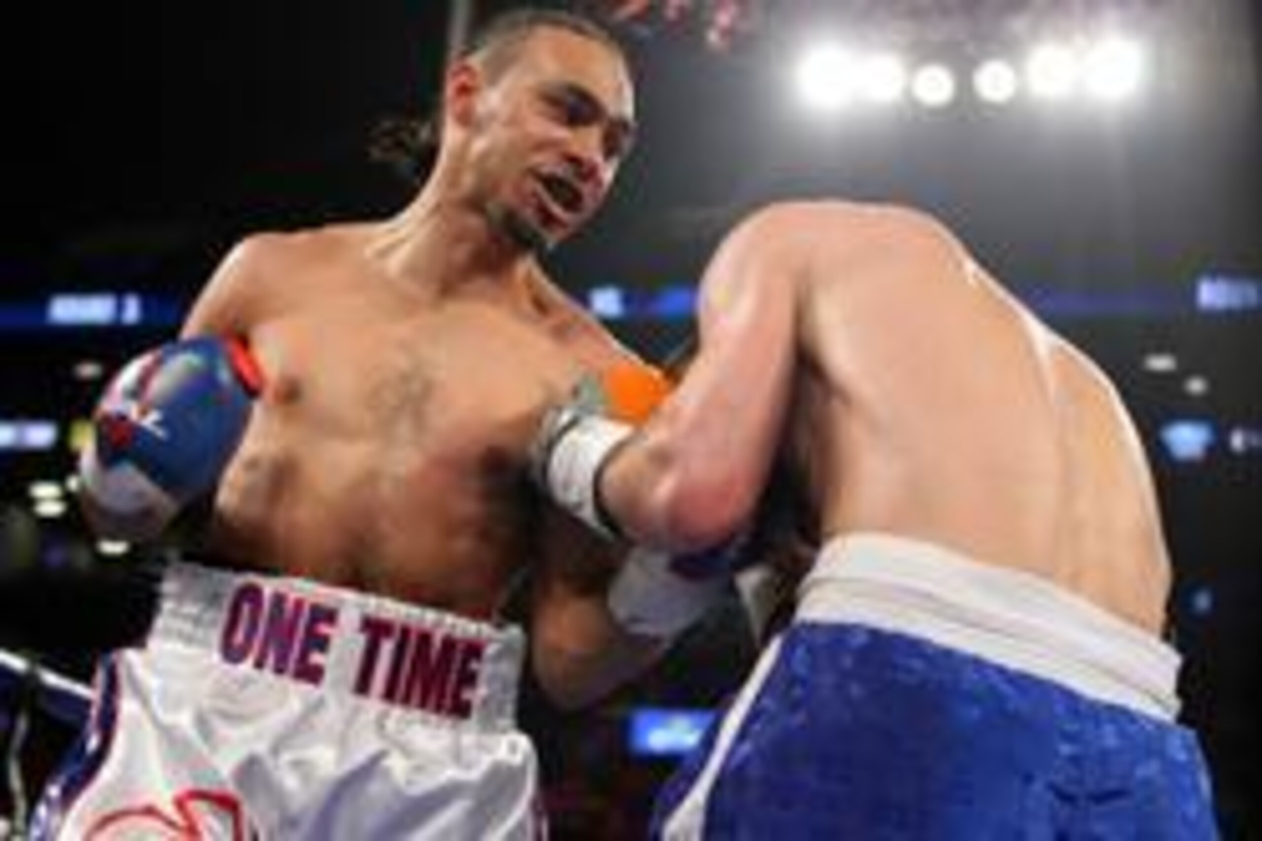 Mar 9, 2013; Brooklyn, NY, USA; Keith Thurman (red/white/blue trunks) and Jan Zaveck (blue trunks) trade punches during their 12 round WBO Inter-Continental Welterweight title bout at the Barclay's Center.  Mandatory Credit: Ed Mulholland-USA TODAY Sports