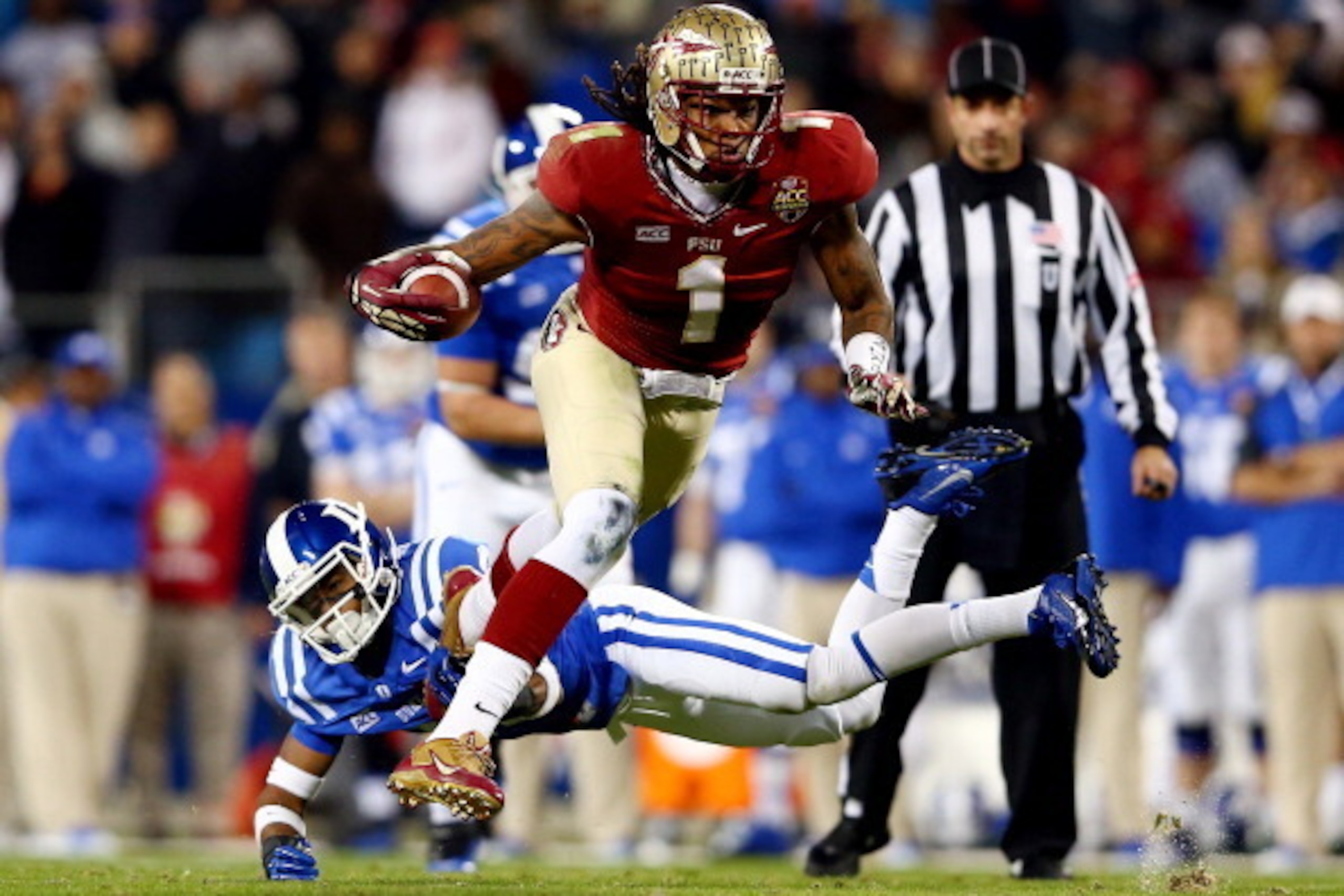 CHARLOTTE, NC - DECEMBER 07:  Wide receiver Kelvin Benjamin #1 of the Florida State Seminoles runs with the ball as cornerback Deondre Singleton #33 of the Duke Blue Devils defends during the ACC Championship game at Bank of America Stadium on December 7,