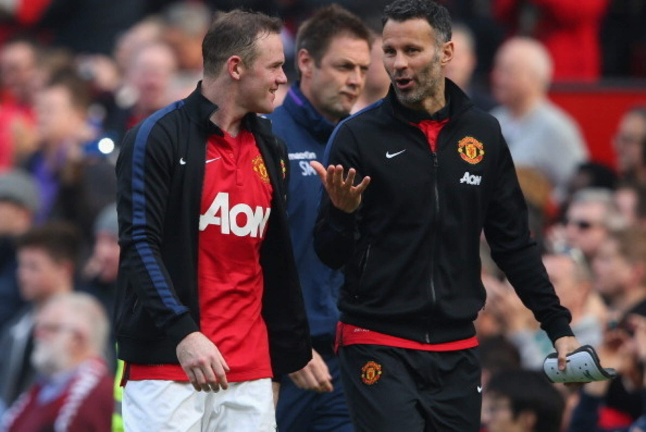 MANCHESTER, ENGLAND - MARCH 29:  Wayne Rooney of Manchester United walks off with Ryan Giggs (R) at the end of the Barclays Premier League match between Manchester United and Aston Villa at Old Trafford on March 29, 2014 in Manchester, England.  (Photo by