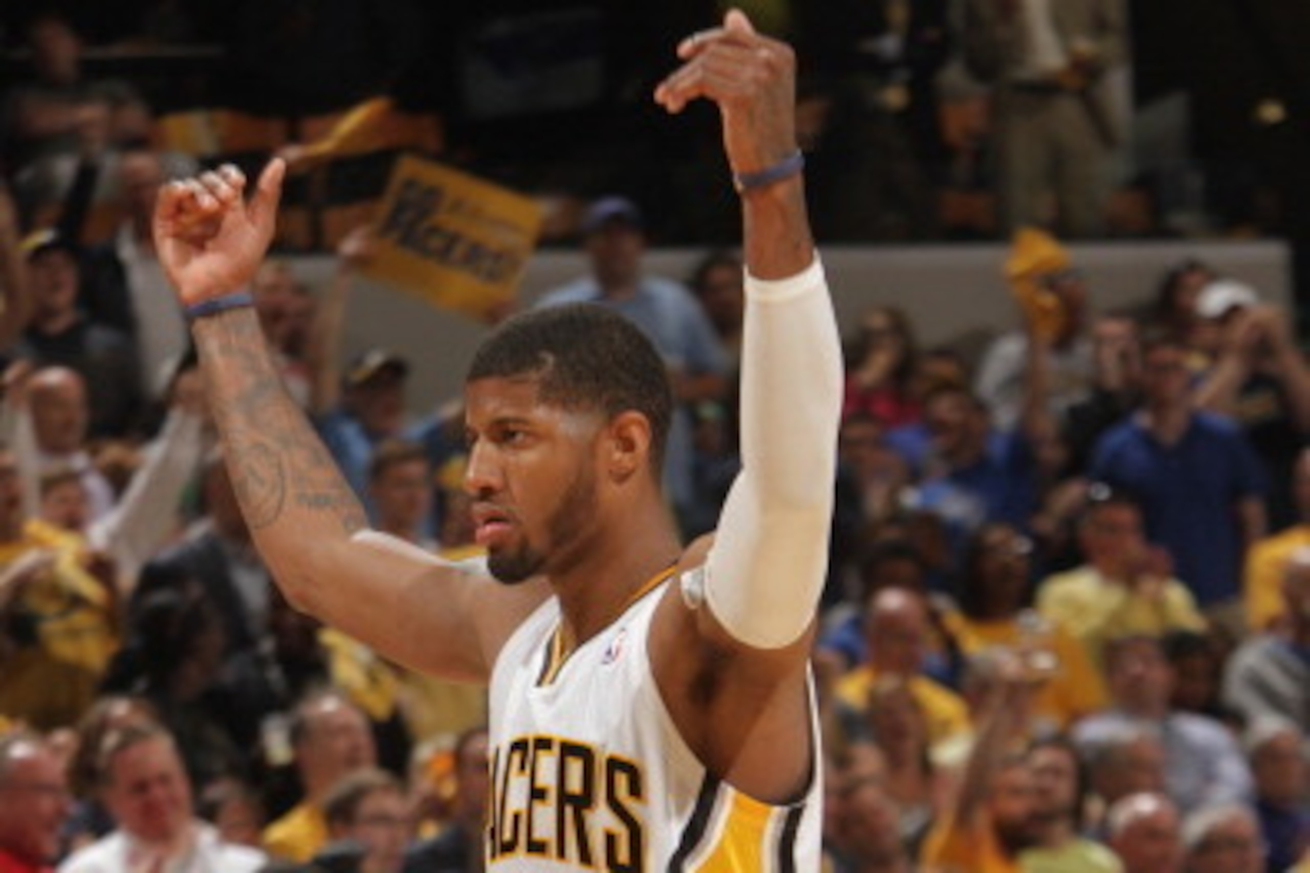 INDIANAPOLIS - APRIL 22: Paul George #24 of the Indiana Pacers gets the crowd pumped up against the Atlanta Hawks in the East Conference Quarter Finals Game Two at Bankers Life Fieldhouse on April 22 2014 in Indianapolis, Indiana.  NOTE TO USER: User expr
