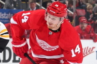 DETROIT, MI - APRIL 22:  Gustav Nyquist #14 of the Detroit Red Wings shoots the puck as Patrice Bergeron #37 of the Boston Bruins skates behind during Game Three of the First Round of the 2014 Stanley Cup Playoffs on April 22, 2014 at Joe Louis Arena in D