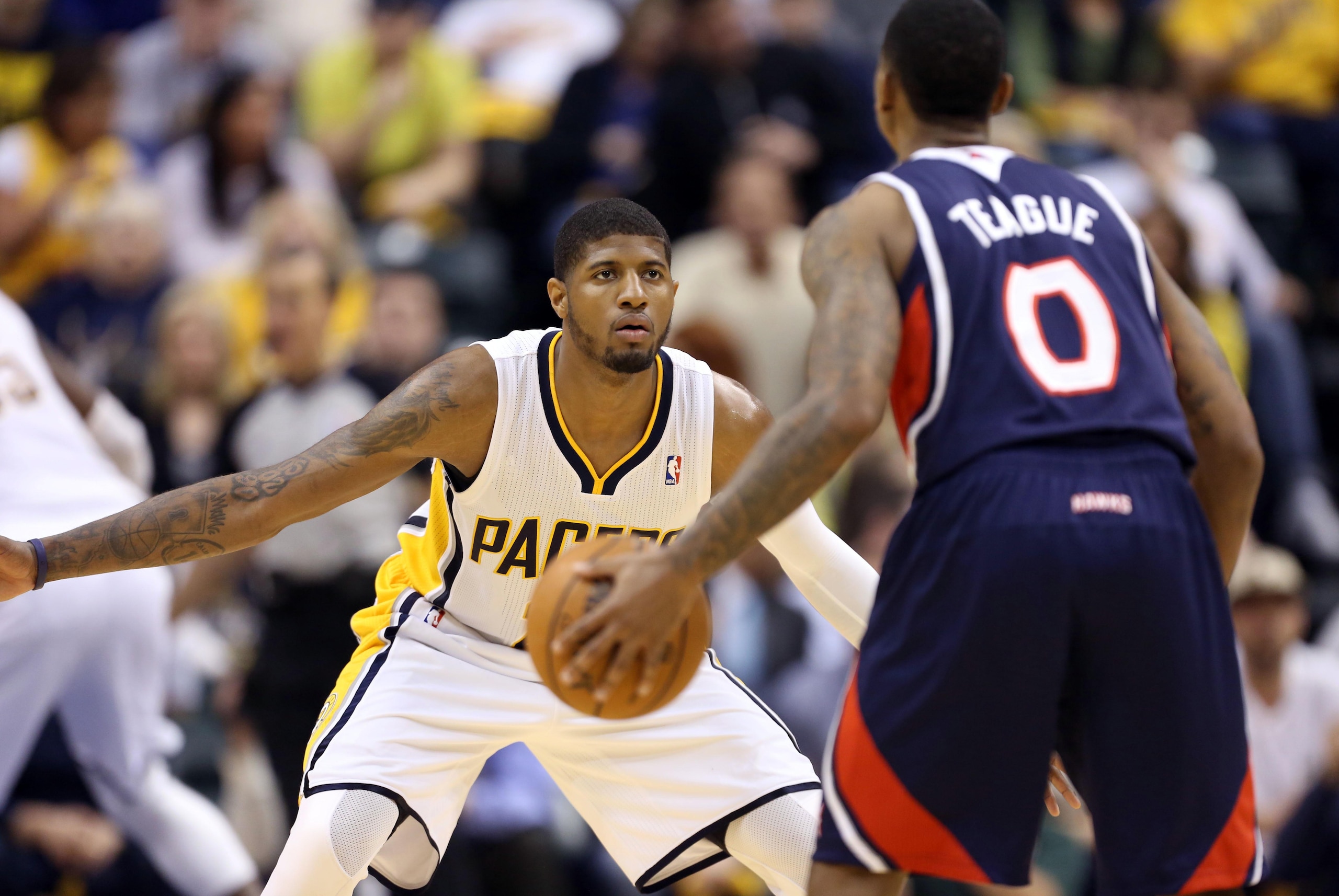 Apr 22, 2014; Indianapolis, IN, USA; Indiana Pacers forward Paul George (24) guards Atlanta Hawks guard Jeff Teague (0) in game two during the first round of the 2014 NBA Playoffs at Bankers Life Fieldhouse. Indiana defeats Atlanta 101-85. Mandatory Credi