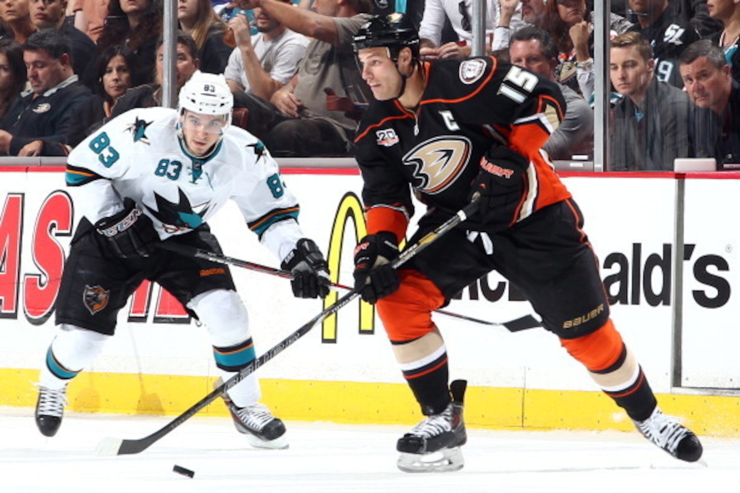 ANAHEIM, CA - APRIL 9: Ryan Getzlaf #15 of the Anaheim Ducks handles the puck against Matt Nieto #83 of the San Jose Sharks on April 9, 2014 at Honda Center in Anaheim, California. (Photo by Debora Robinson/NHLI via Getty Images)