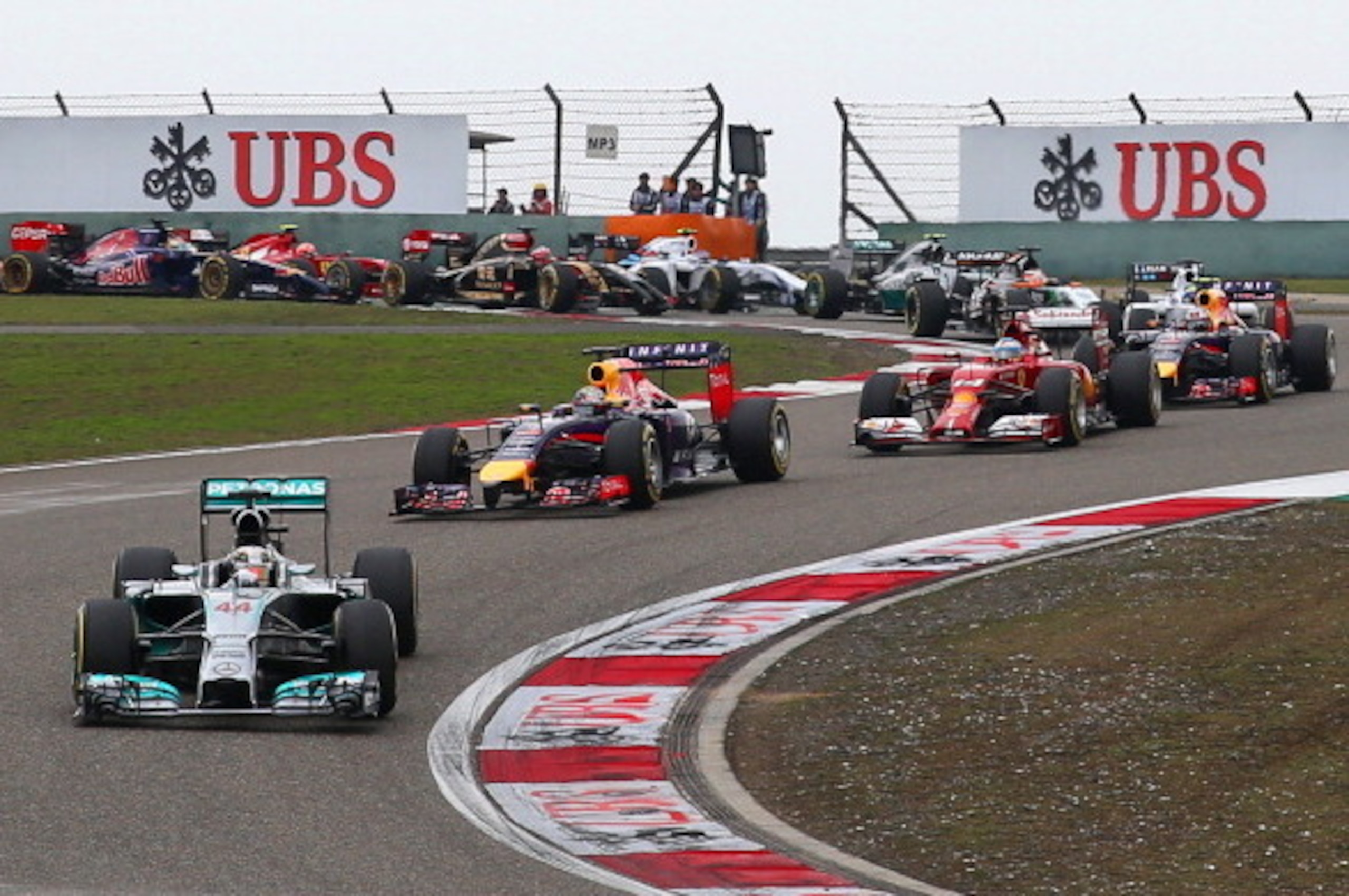 SHANGHAI, CHINA - APRIL 20:  Lewis Hamilton of Great Britain and Mercedes GP leads Sebastian Vettel of Germany and Infiniti Red Bull Racing and Fernando Alonso of Spain and Ferrari into the third corner during the Chinese Formula One Grand Prix at the Sha