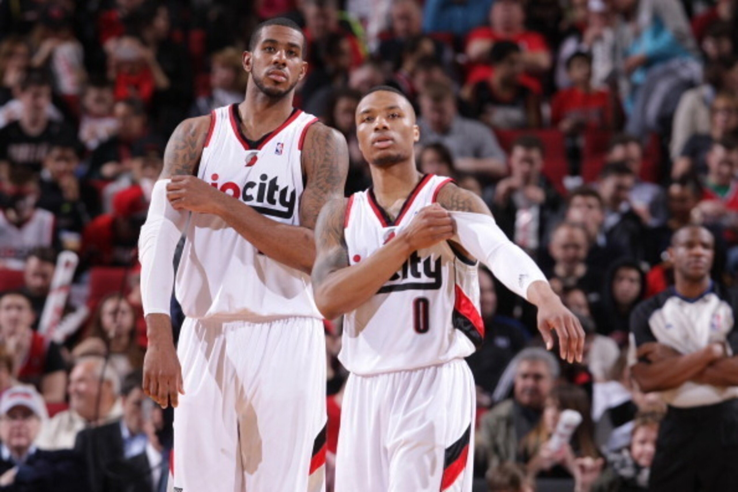 PORTLAND, OR - MARCH 5:  Damian Lillard #0 and LaMarcus Aldridge #12 of the Portland Trail Blazers stand on the court against the Atlanta Hawks on March 5, 2014 at the Moda Center Arena in Portland, Oregon. NOTE TO USER: User expressly acknowledges and ag