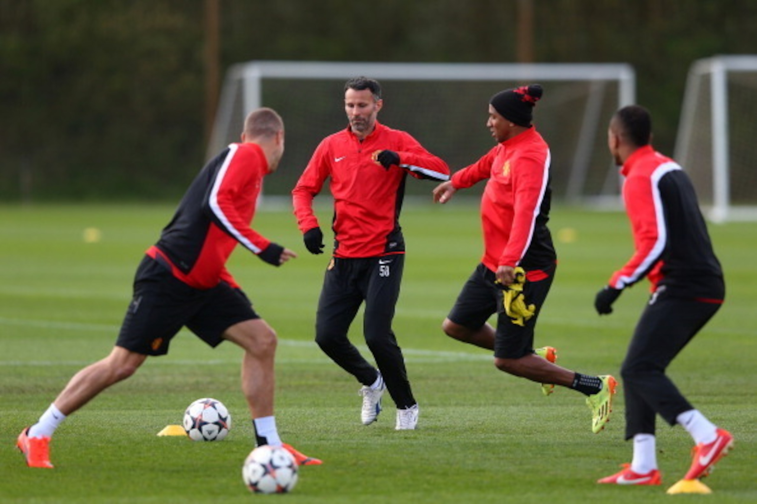 MANCHESTER, ENGLAND - APRIL 08:  Ashley Young of Manchester United challenges Ryan Giggs during a training session at Aon Training Complex on April 8, 2014 in Manchester, England.  (Photo by Alex Livesey/Getty Images)