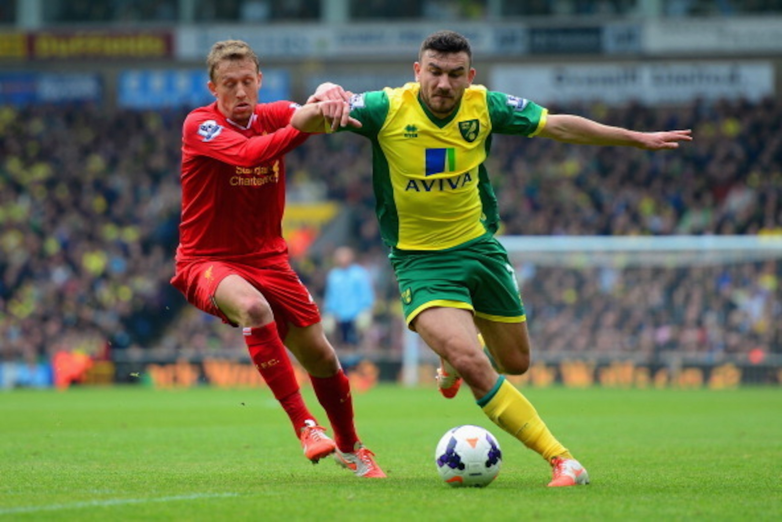 NORWICH, ENGLAND - APRIL 20:  Lucas Leiva of Liverpool and Robert Snodgrass of Norwich City battle for the ball during the Barclays Premier League match between Norwich City and Liverpool at Carrow Road on April 20, 2014 in Norwich, England.  (Photo by Ja