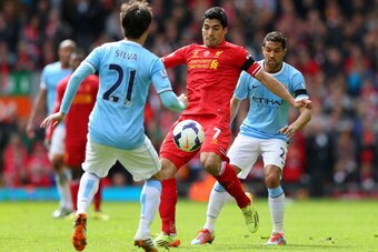 LIVERPOOL, ENGLAND - APRIL 13:  Luis Suarez of Liverpool competes with Gael Clichy and David Silva of Manchester City uring the Barclays Premier League match between Liverpool and Manchester City at Anfield on April 13, 2014 in Liverpool, England.  (Photo