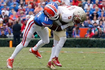 GAINESVILLE, FL - NOVEMBER 30:  Neiron Ball #11 of the Florida Gators tackles Jameis Winston #5 of the Florida State Seminoles  during the game on November 30, 2013 in Gainesville, Florida.  (Photo by Sam Greenwood/Getty Images)