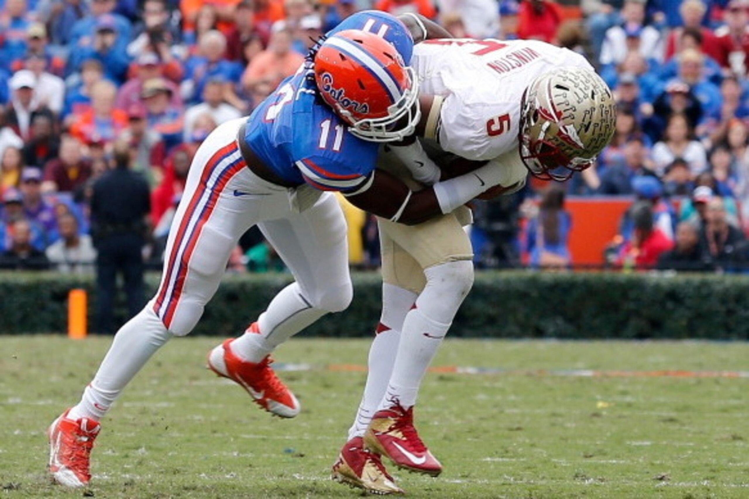 GAINESVILLE, FL - NOVEMBER 30:  Neiron Ball #11 of the Florida Gators tackles Jameis Winston #5 of the Florida State Seminoles  during the game on November 30, 2013 in Gainesville, Florida.  (Photo by Sam Greenwood/Getty Images)