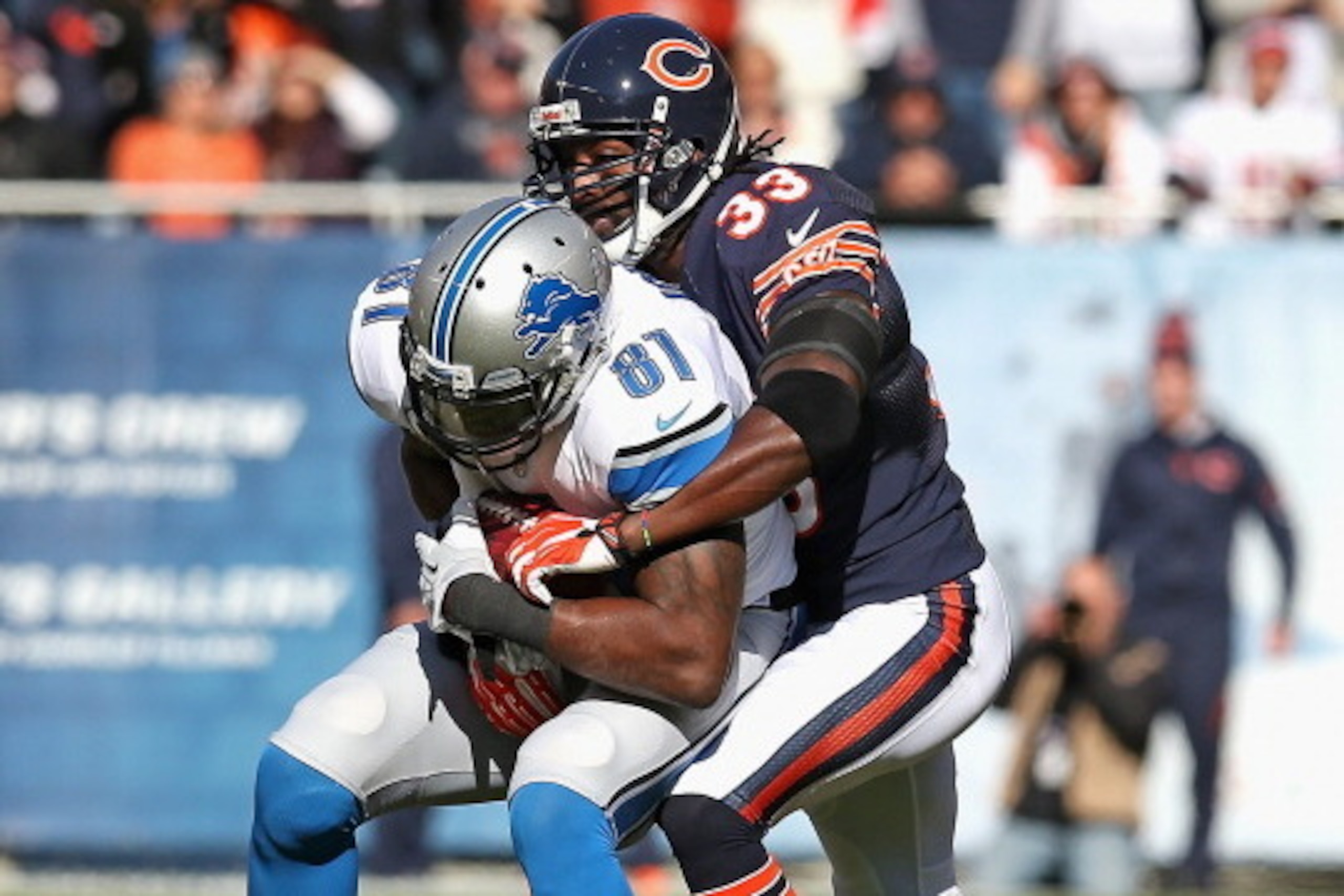 CHICAGO, IL - NOVEMBER 10:  Charles Tillman #33 of the Chicago Bears tackles Calvin Johnson #81 of the Detroit Lions at Soldier Field on November 10, 2013 in Chicago, Illinois. The Lions defeated the Bears 21-19.  (Photo by Jonathan Daniel/Getty Images)