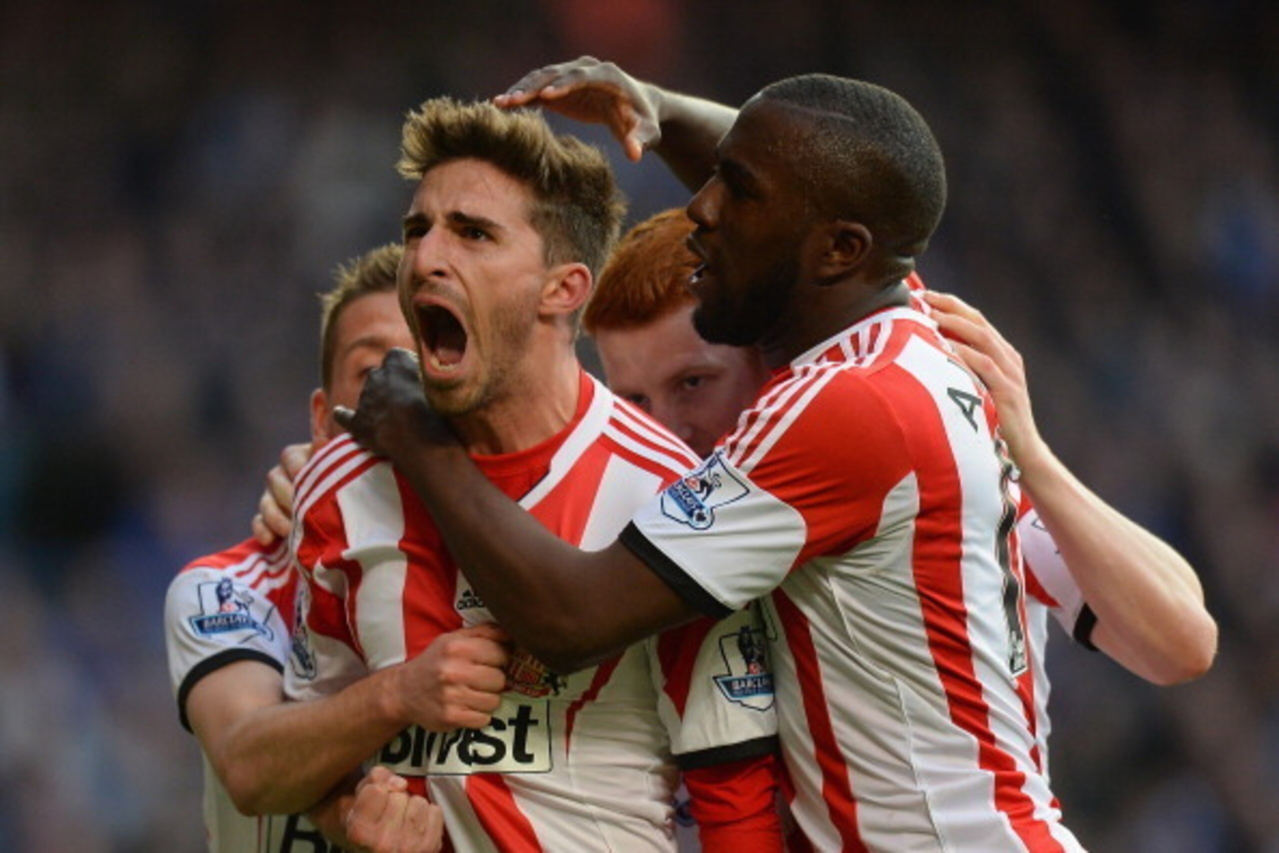 LONDON, ENGLAND - APRIL 19:  Fabio Borini of Sunderland is mobbed by team mates after scoring the winner from the penalty spot during the Barclays Premier League match between Chelsea and Sunderland at Stamford Bridge on April 19, 2014 in London, England.